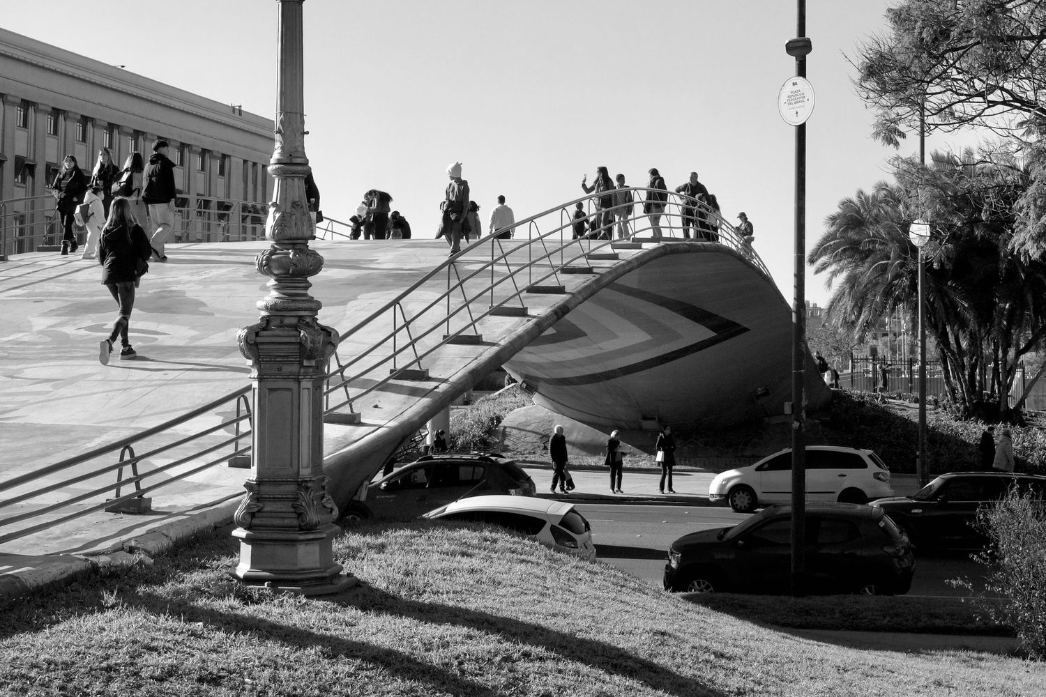 People silhouetted against sunset on urban steps and walkways.