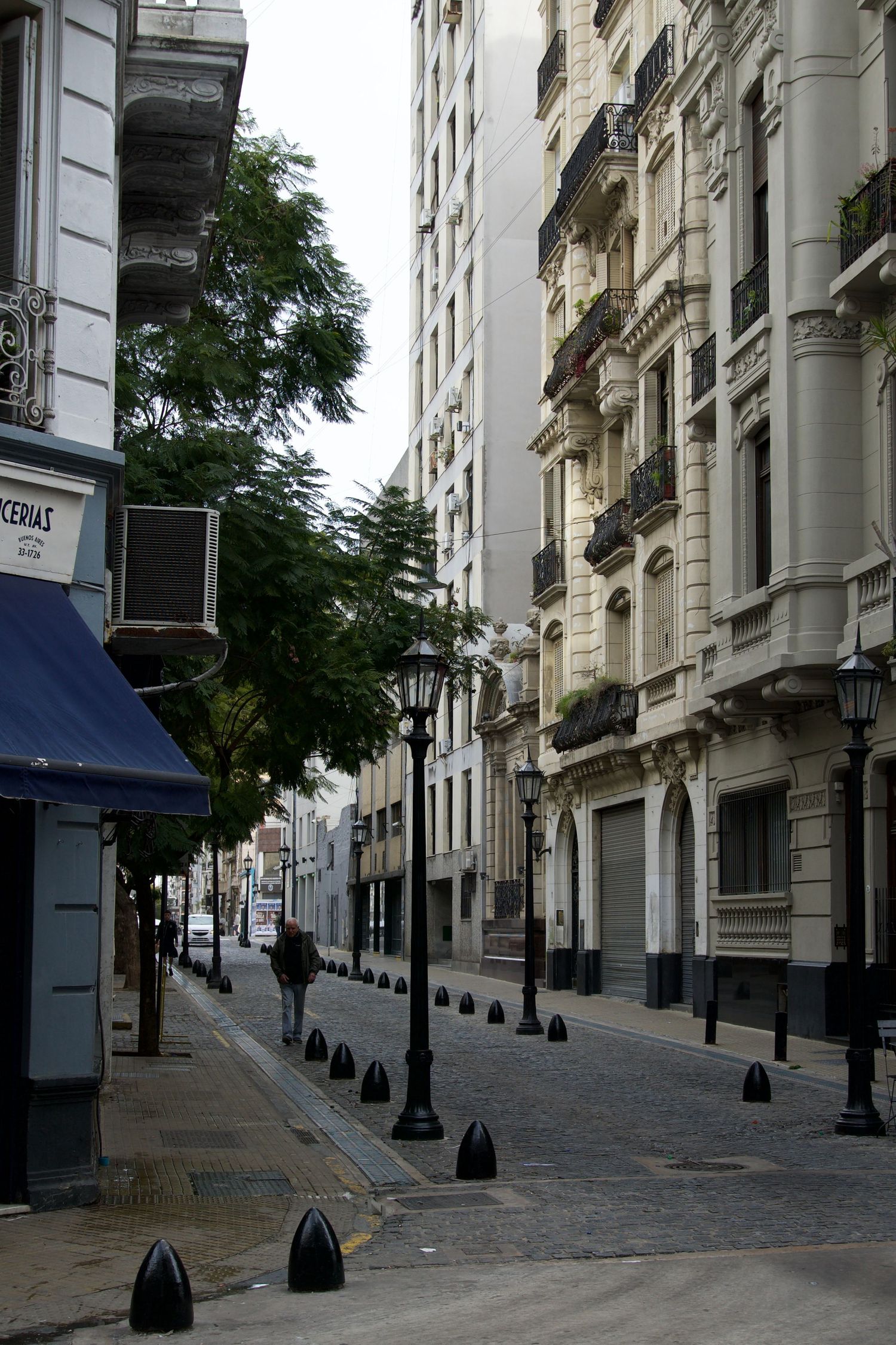 Empty historic street lined with elegant European-style buildings and ornate lampposts.