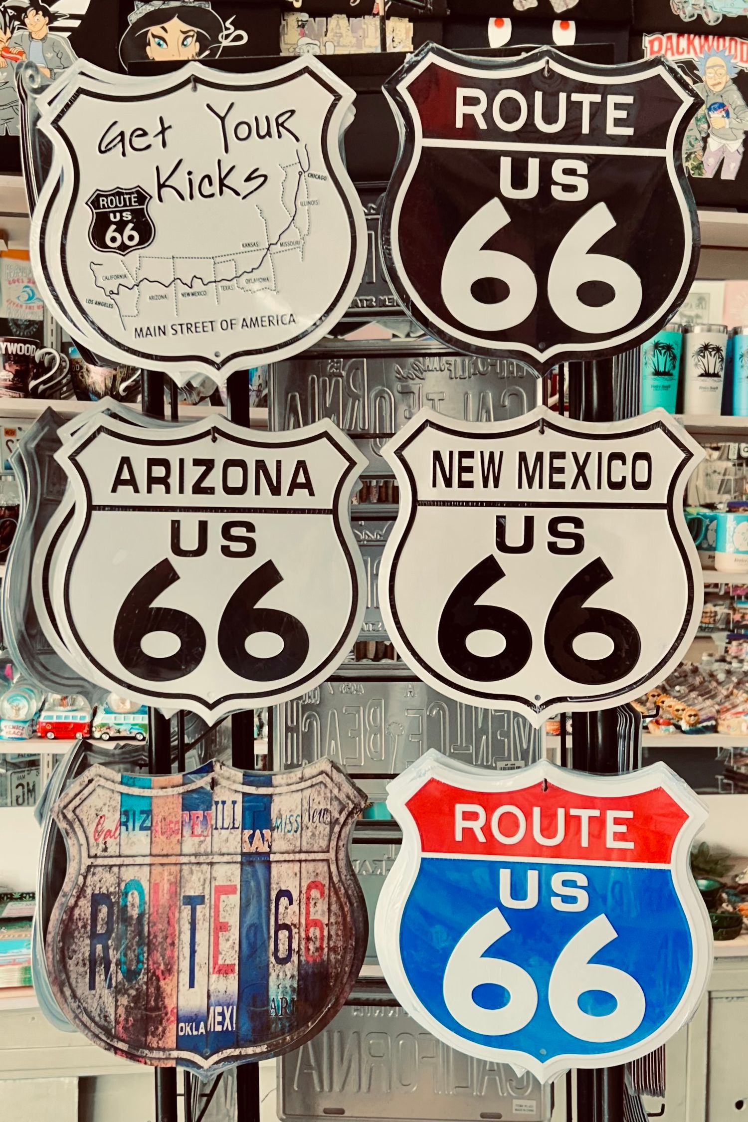 Collection of vintage Route 66 road signs from different states displayed together.
