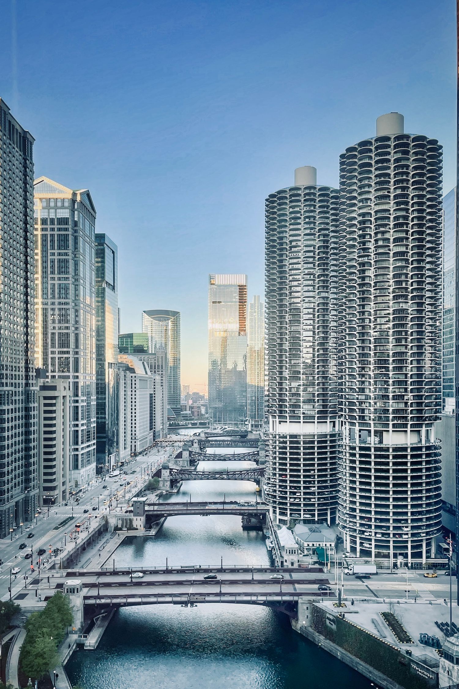 Modern Chicago cityscape with Marina City towers and bridges spanning the river in winter.