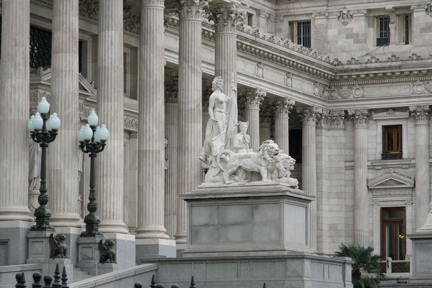 Neoclassical architecture featuring grand white columns and ornate stonework details.