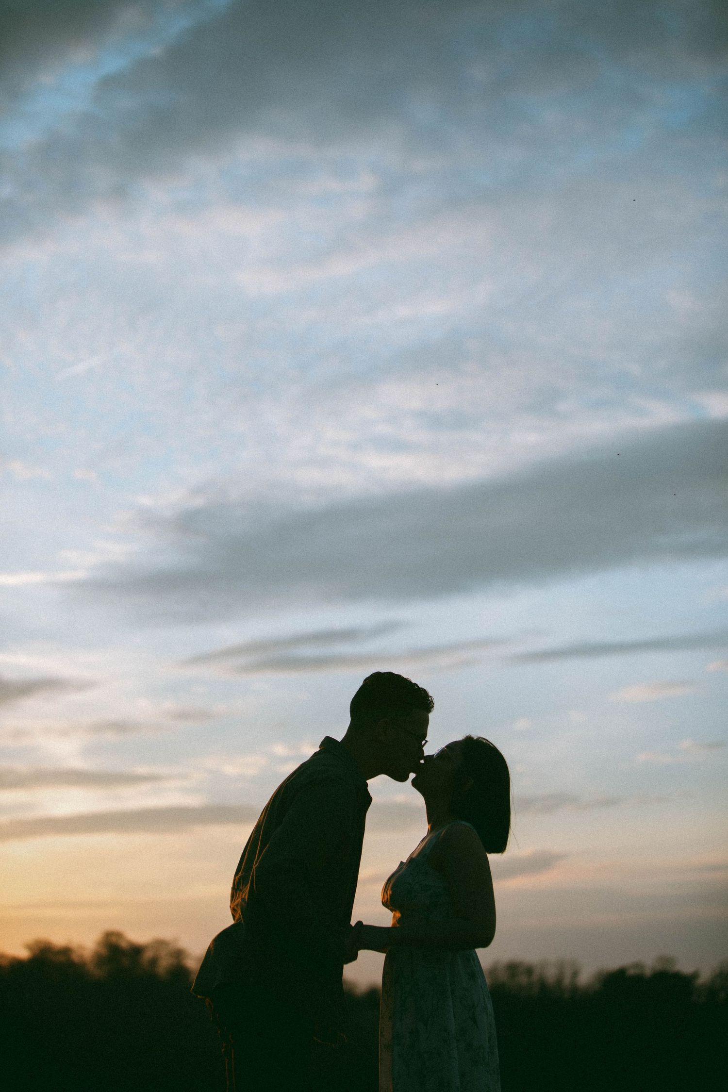 Silhouetted couple in romantic embrace from a golden hour couples session with D'Gallery Photography in Lancaster, PA.