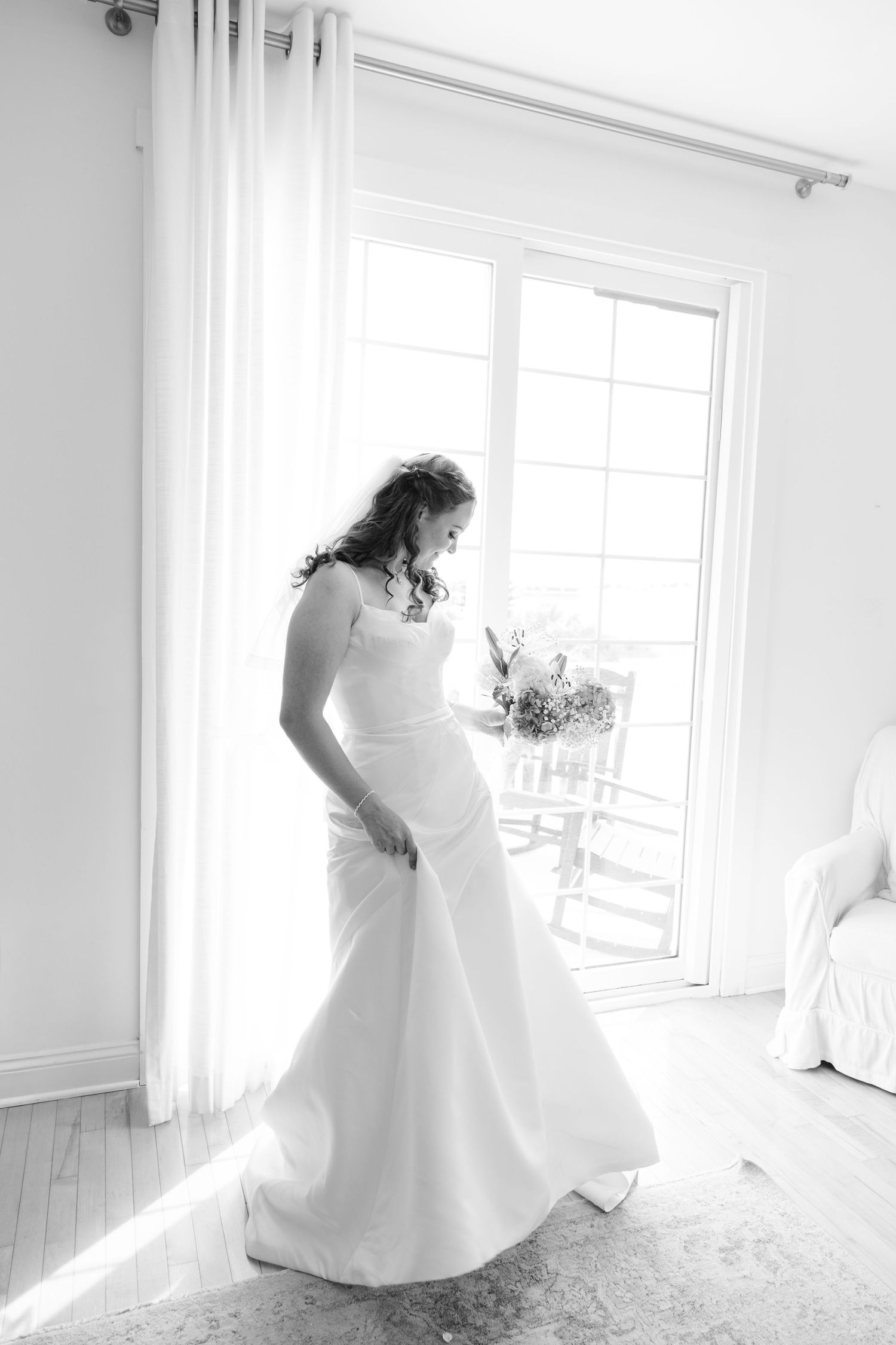 bride twirling in her dress hiding bouquet of flowers