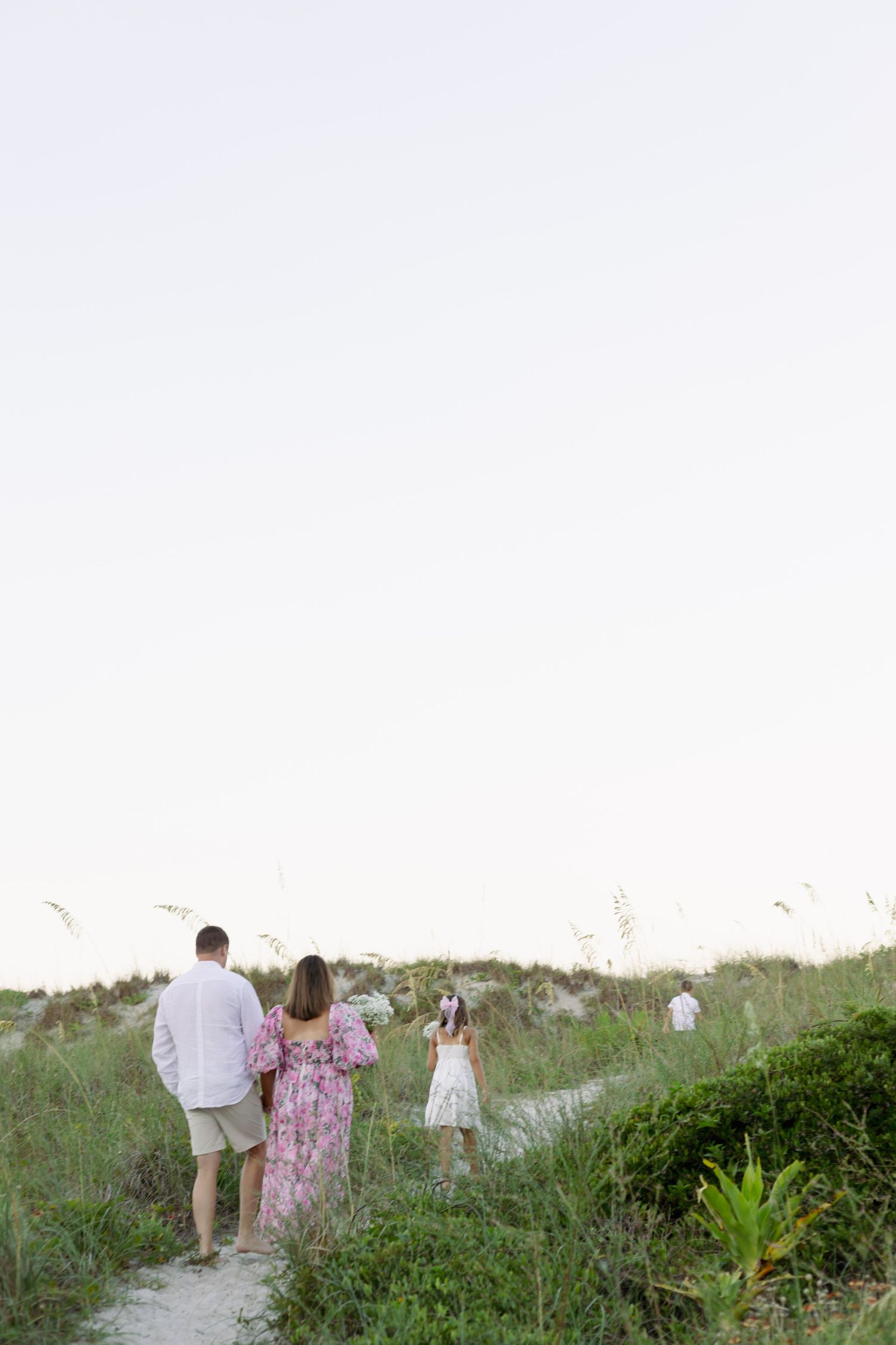 family walk in beach dunes