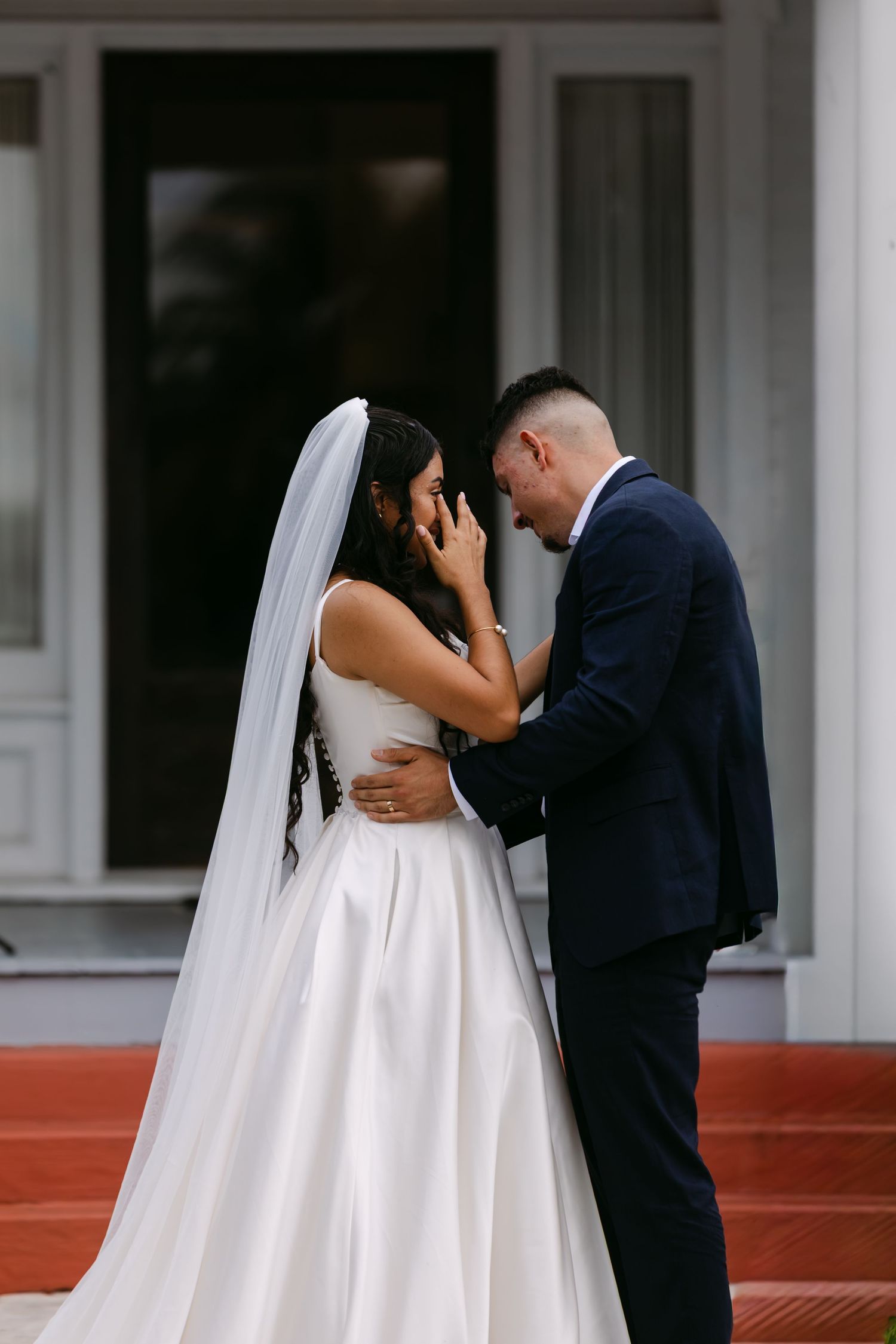A romantic wedding sequence shows a couple sharing their first kiss as newlyweds on red steps.