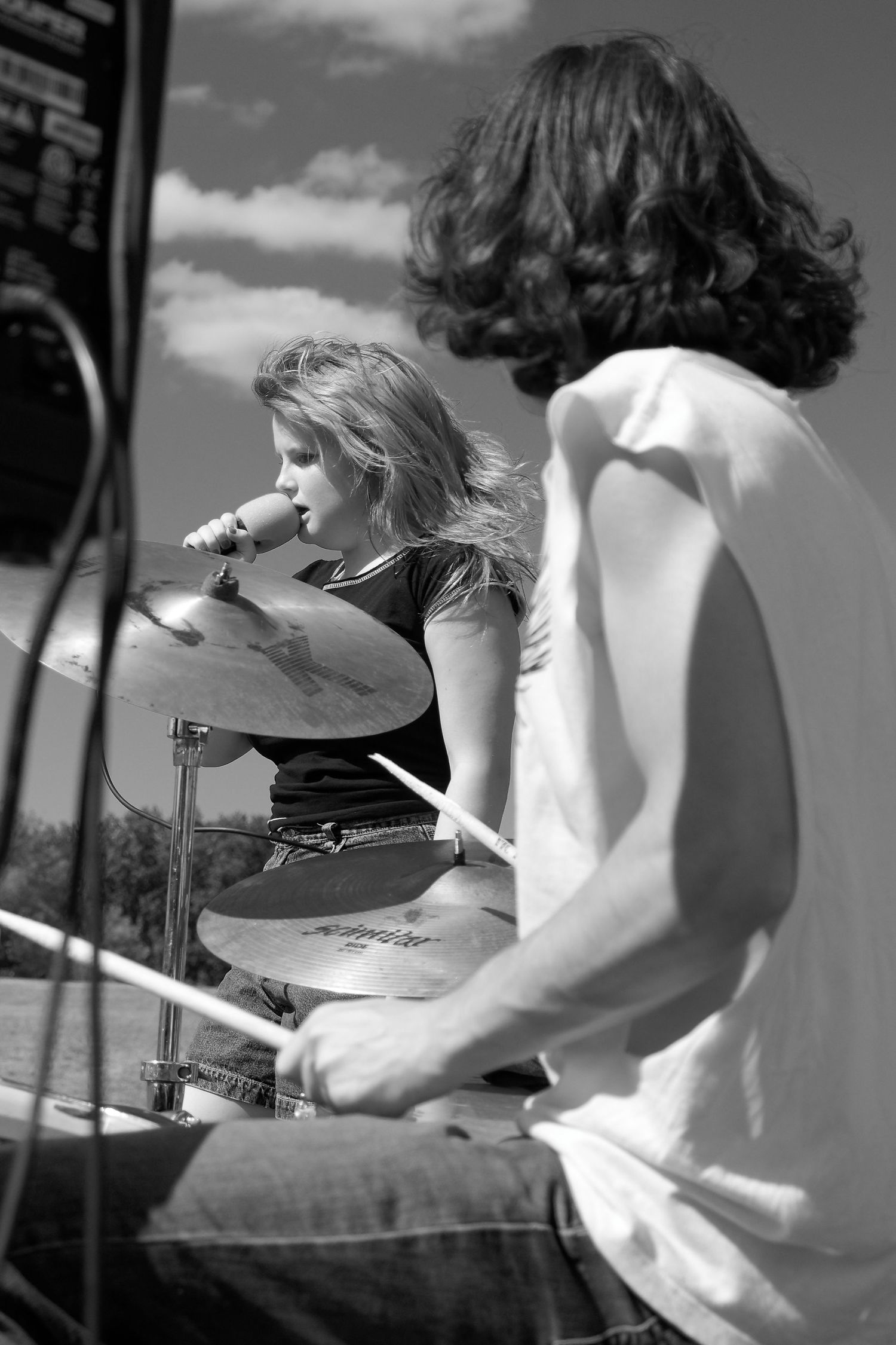 Black and white photo of two musicians performing on stage