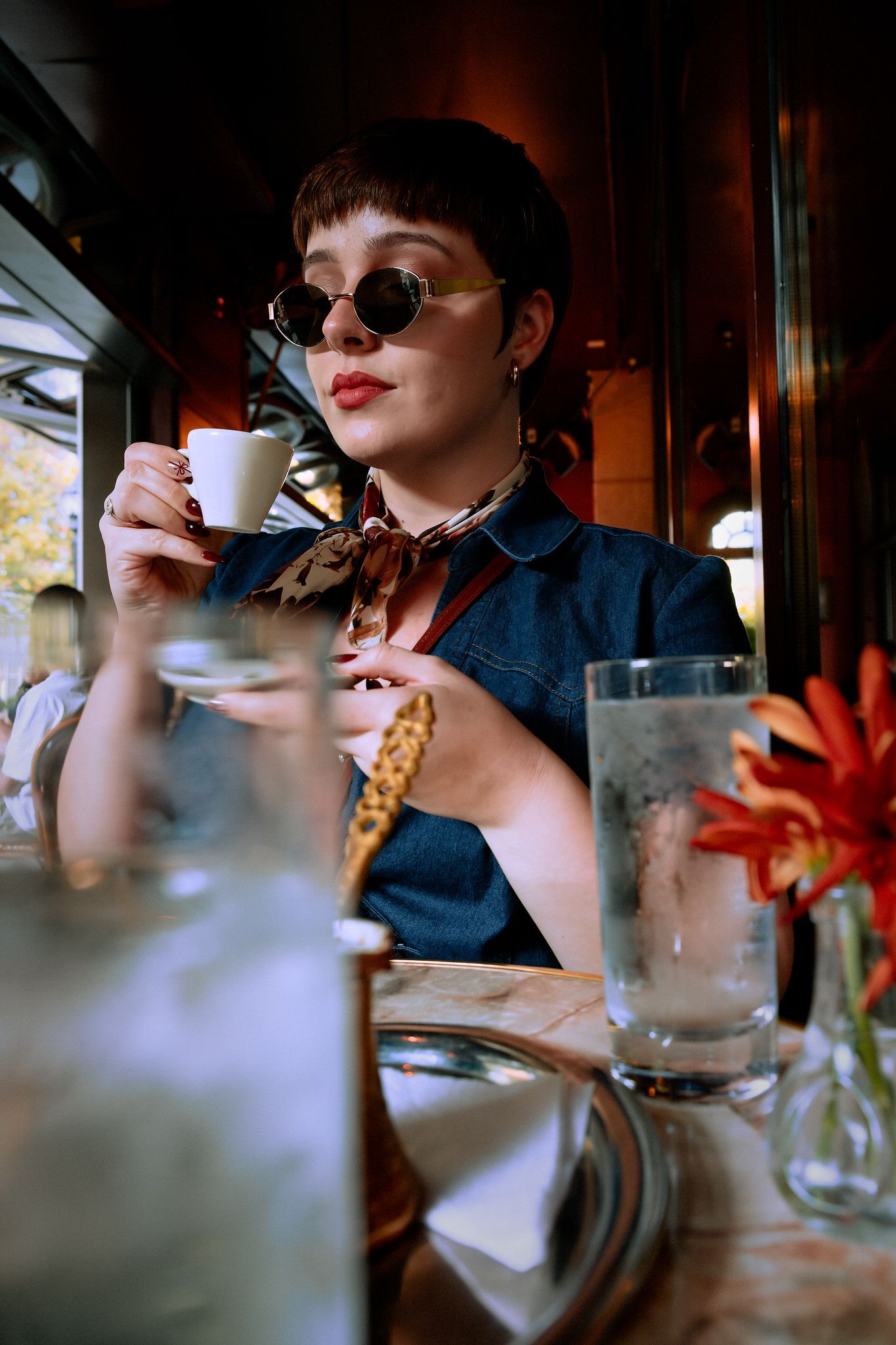 A series of photos showing someone in sunglasses drinking coffee at a cafe table with flowers in the foreground.