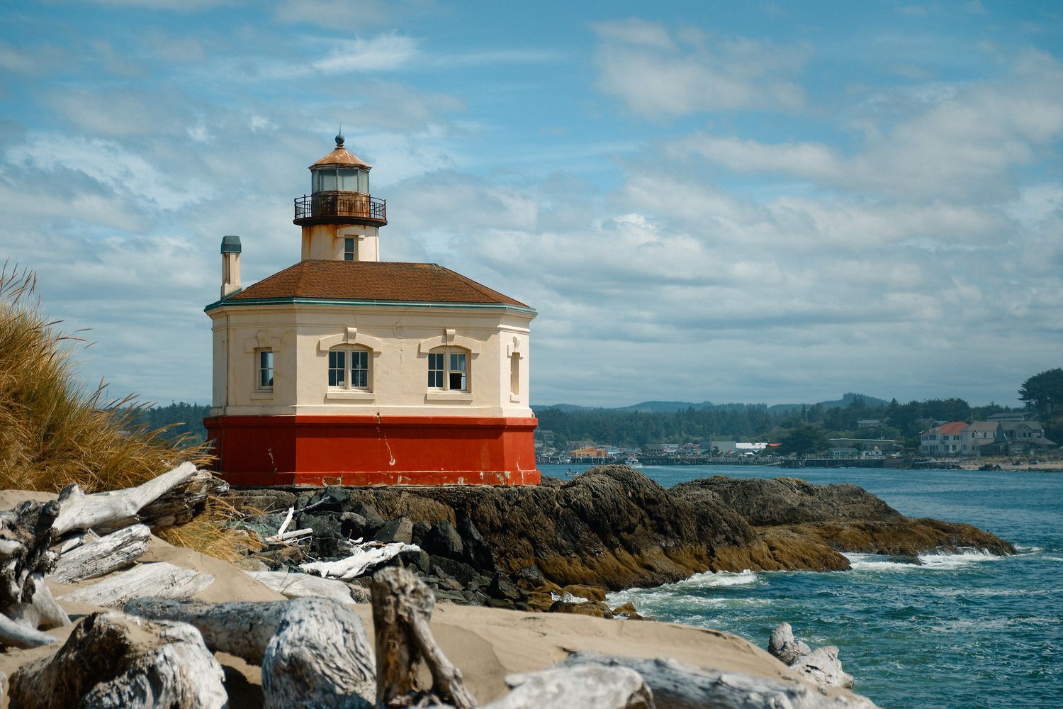 A scenic collage of coastal lighthouses with rocky shores and blue waters along the Pacific Northwest coastline.