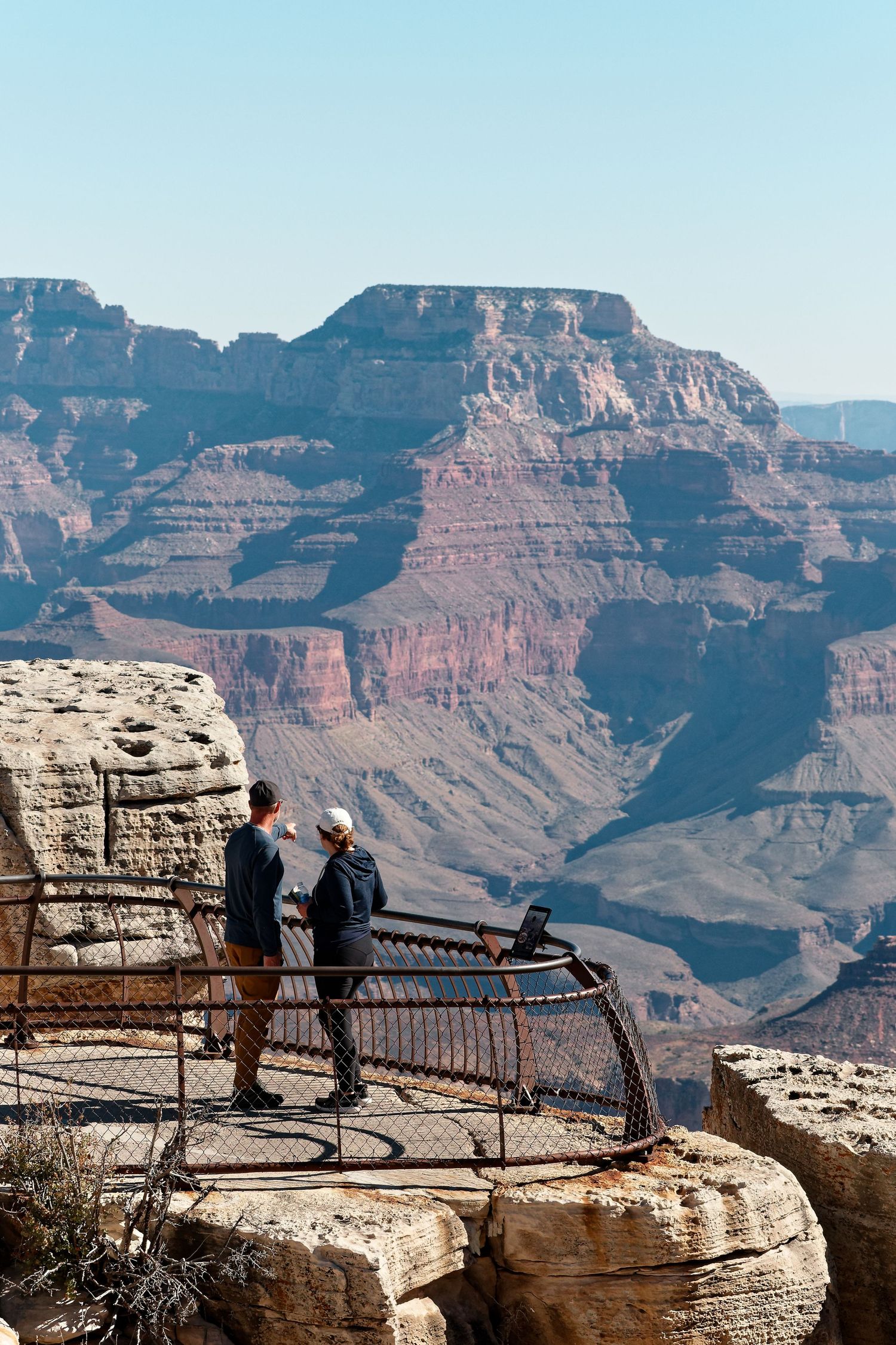 Visitors admire the view from a platform at the Grand Canyon's rim.