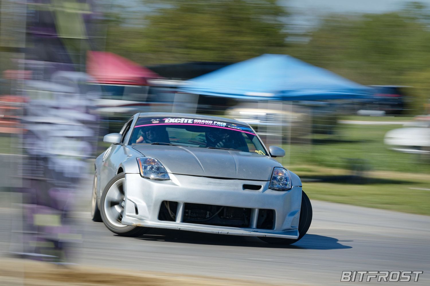 A silver Nissan 350Z drifting around a track corner