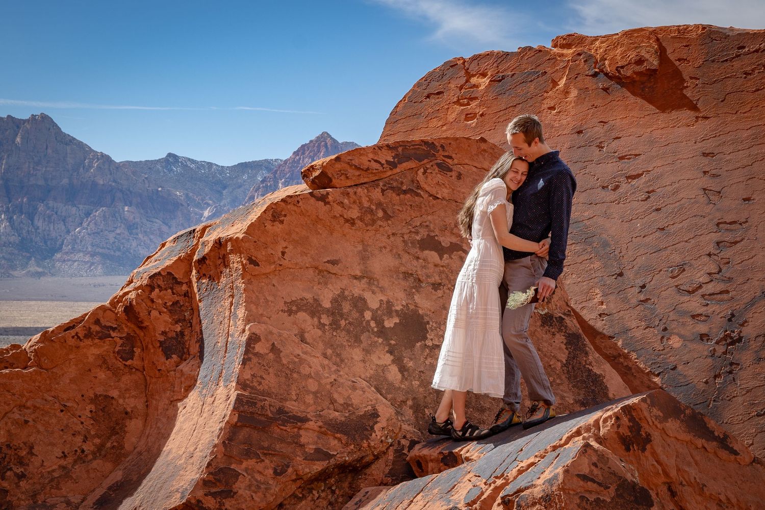 A couple hugs on their wedding day elopement in Red Rocks, Nevada.