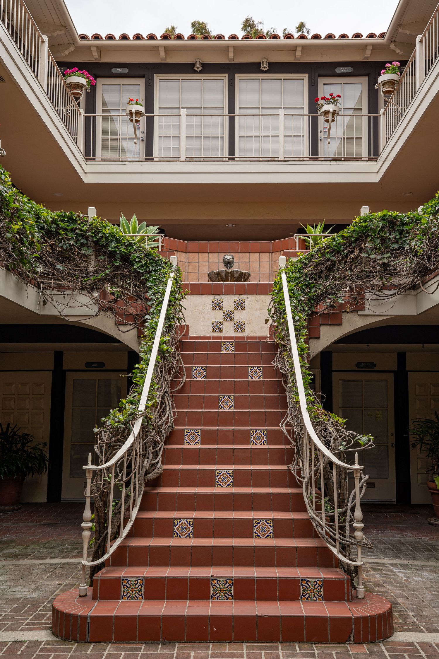 A beautiful ornate staircase in Malaga Cove. It is made of red tile.
