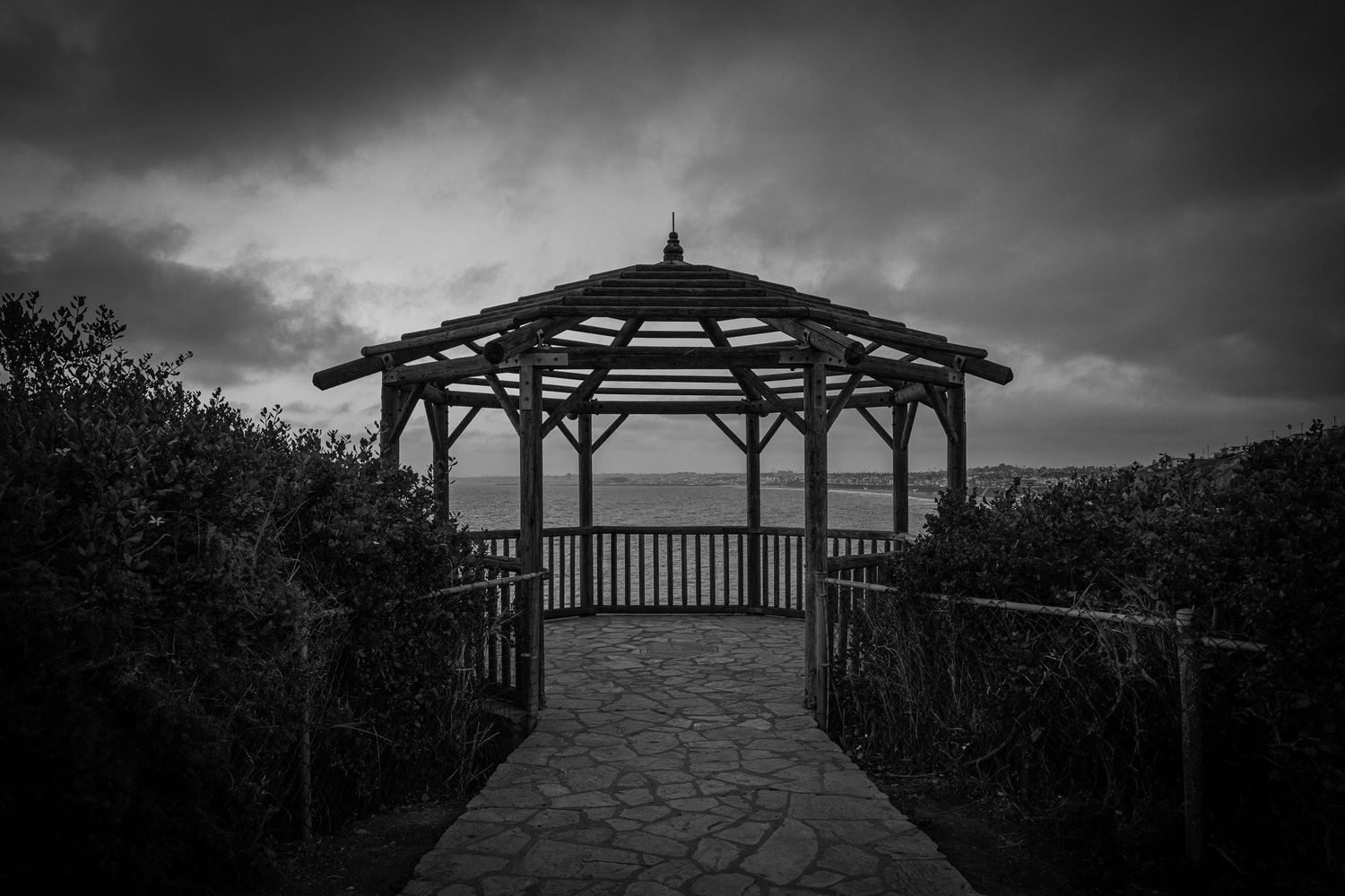 A black and white photo of a secret gazebo overlooking the coast in Palos Verdes.