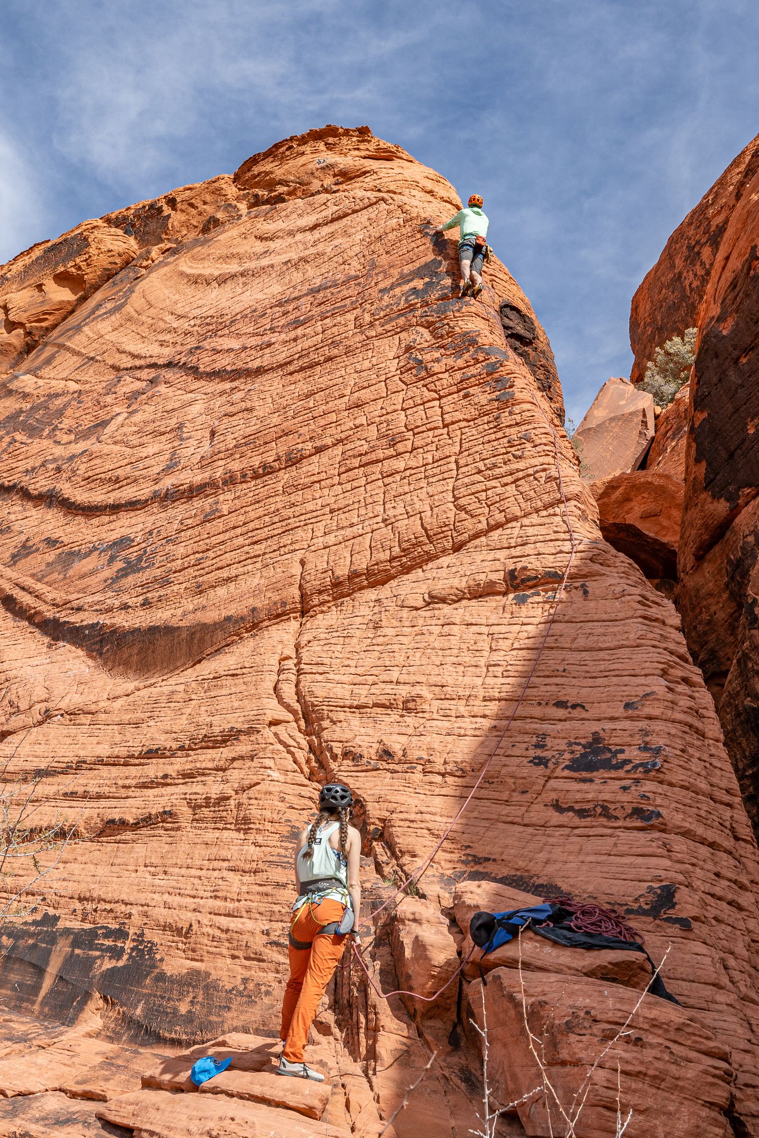 A girl belaying her husband on their elopement day in Red Rocks, Nevada.