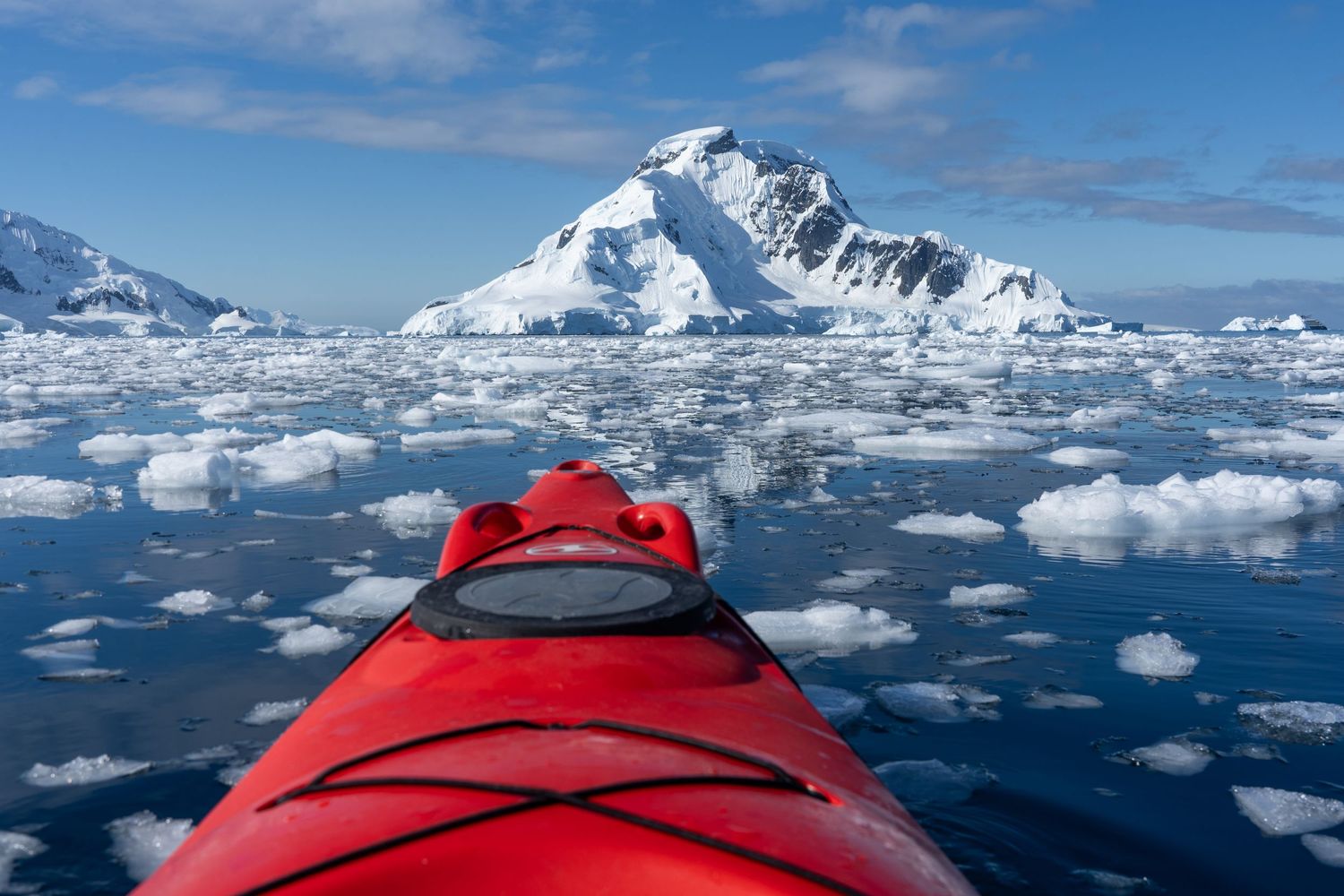 A kayaker glides through the ice strewn waters of Antarctica. What a beautiful destination vow renewal location.