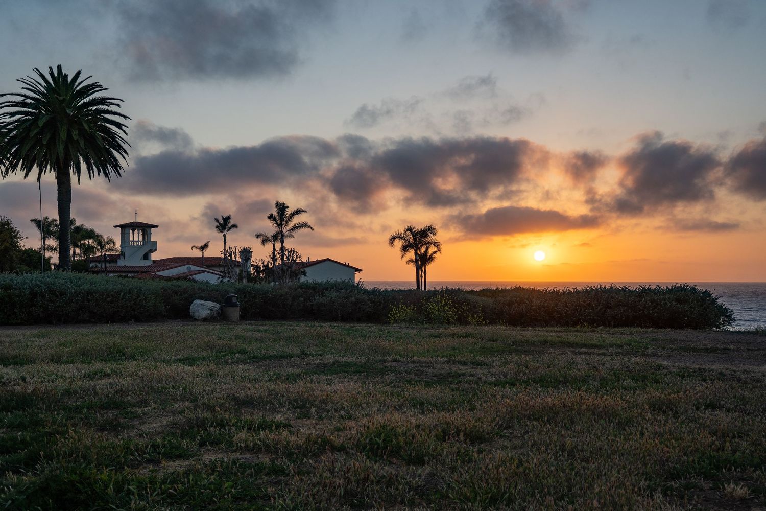 The sun sets behind a church steeple in Palos Verdes.