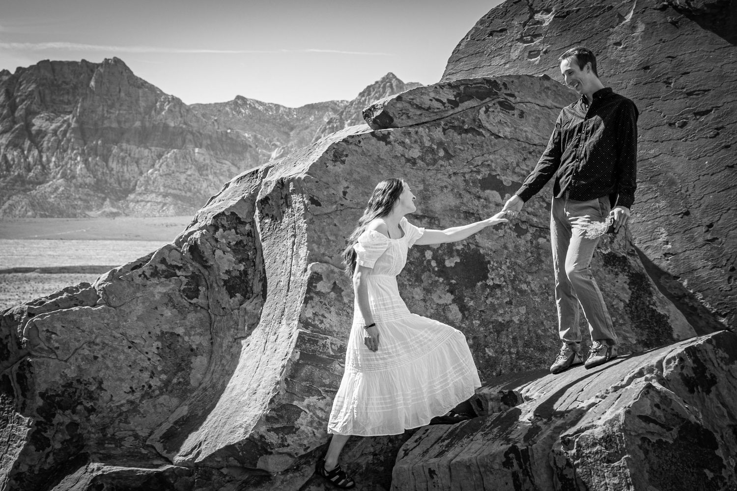 A couple holding hands in the rocks in Red Rocks, Nevada.