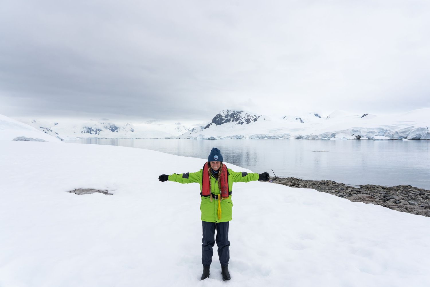 Madison, from Mad Elopements, smiling in the snow in Antarctica.