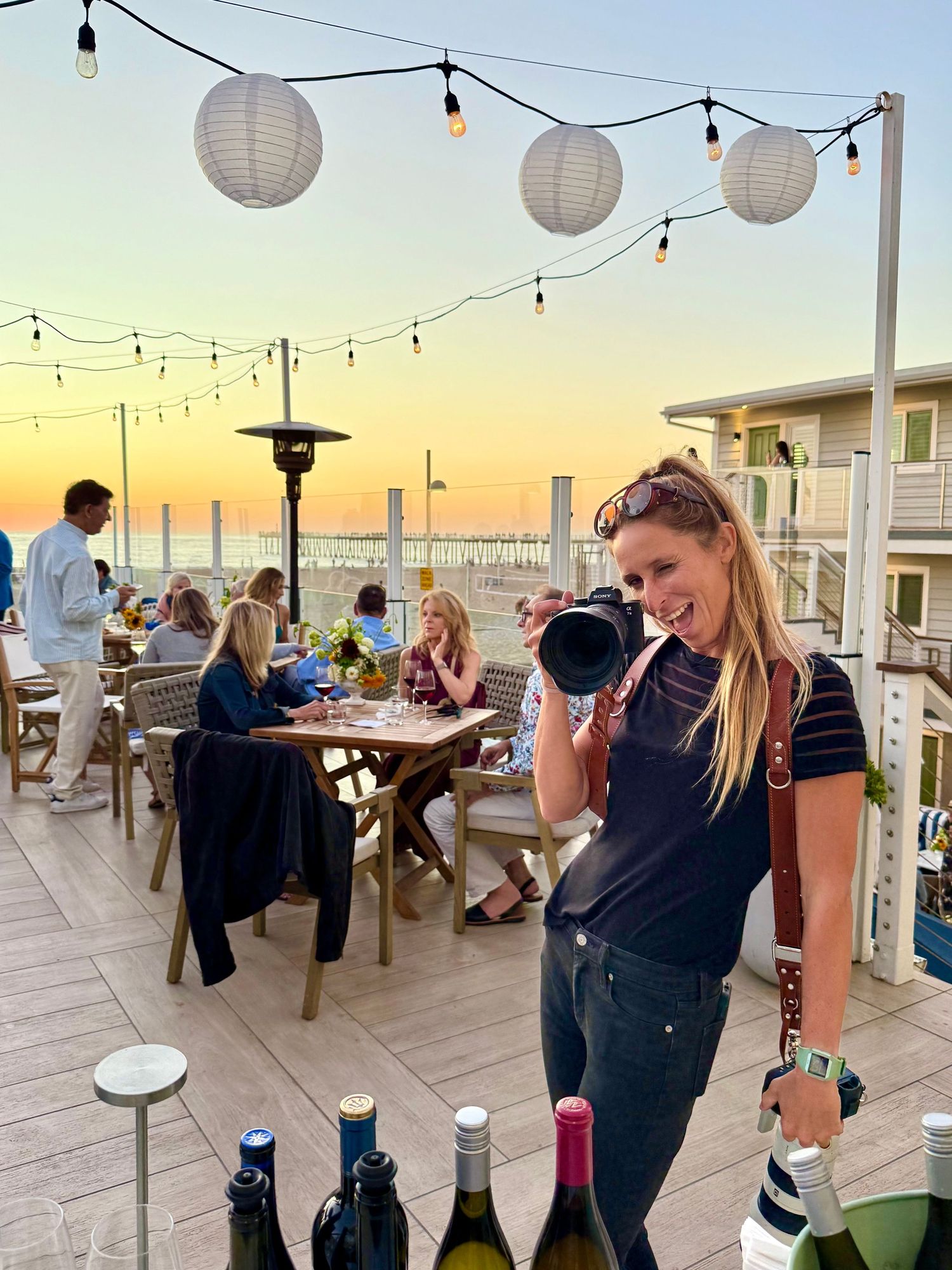 Madison from Mad Elopements shoots a wedding with her Sony cameras in front of a sunset in Hermosa Beach, California.