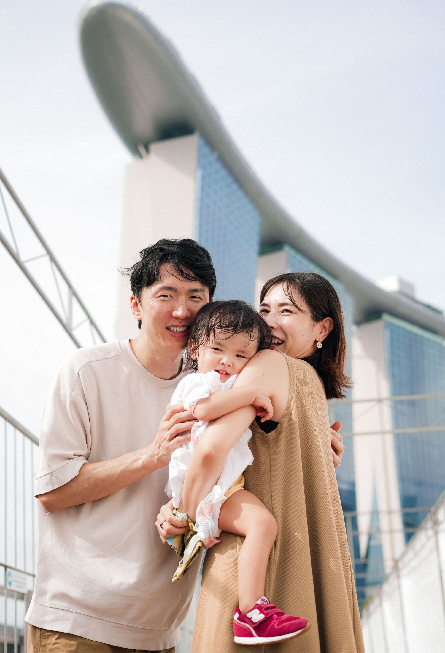 Family enjoying a sunny day together outside Marina Bay Sands in Singapore.