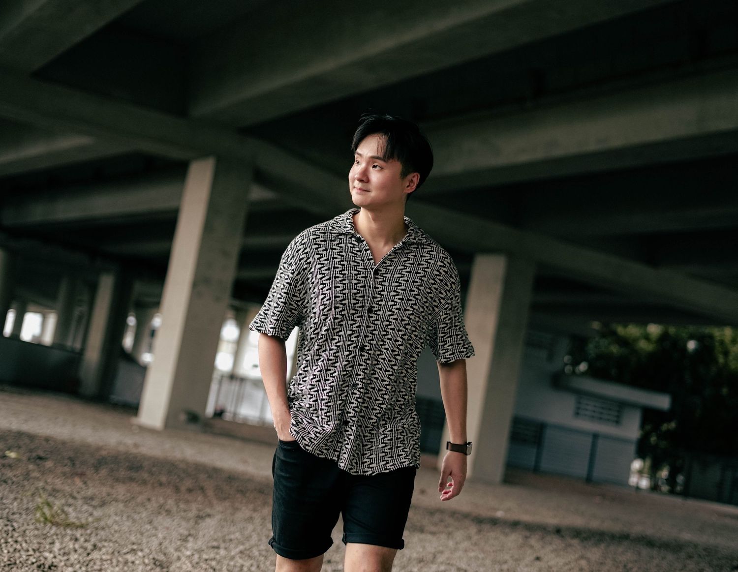 Casual urban portrait under concrete architecture.