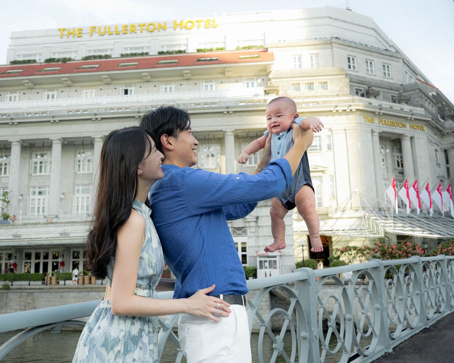 A family moment captured outside the historic Fullerton Hotel in Singapore.