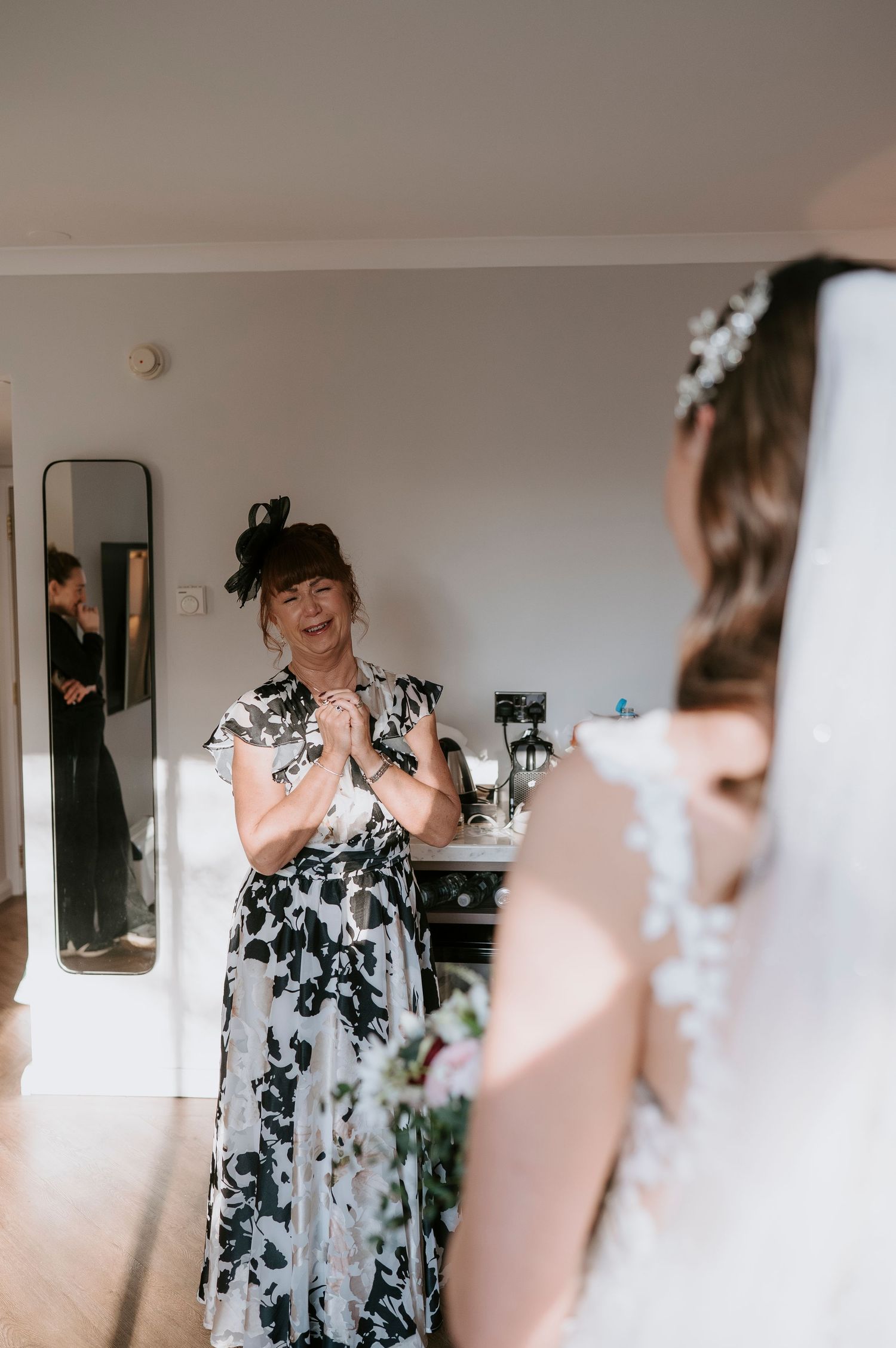 A series of emotional first look reactions captured during a wedding preparation moment in a light-filled room.
