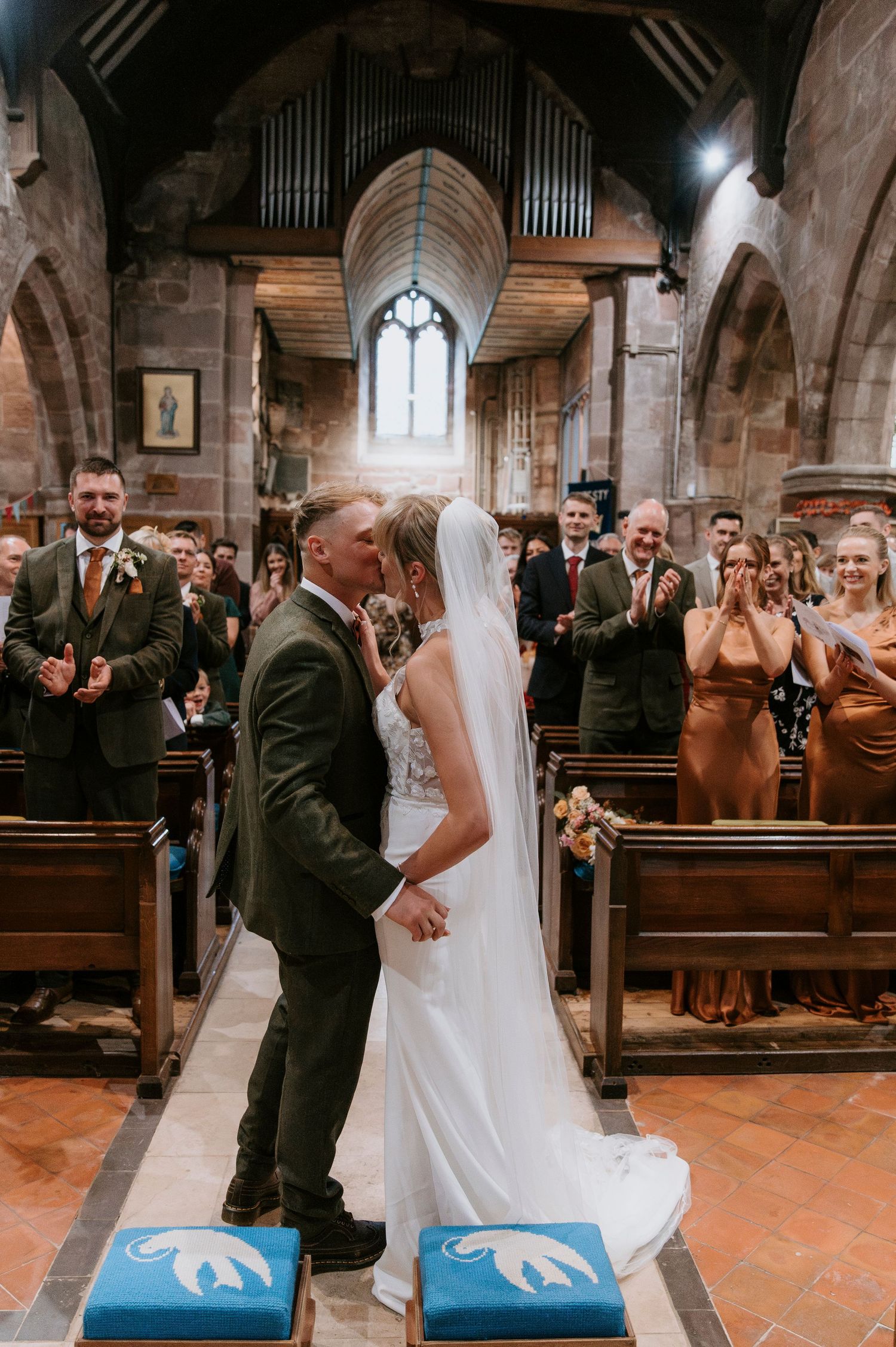 A romantic first dance sequence between newlyweds inside a beautiful historic stone church with vaulted ceilings.