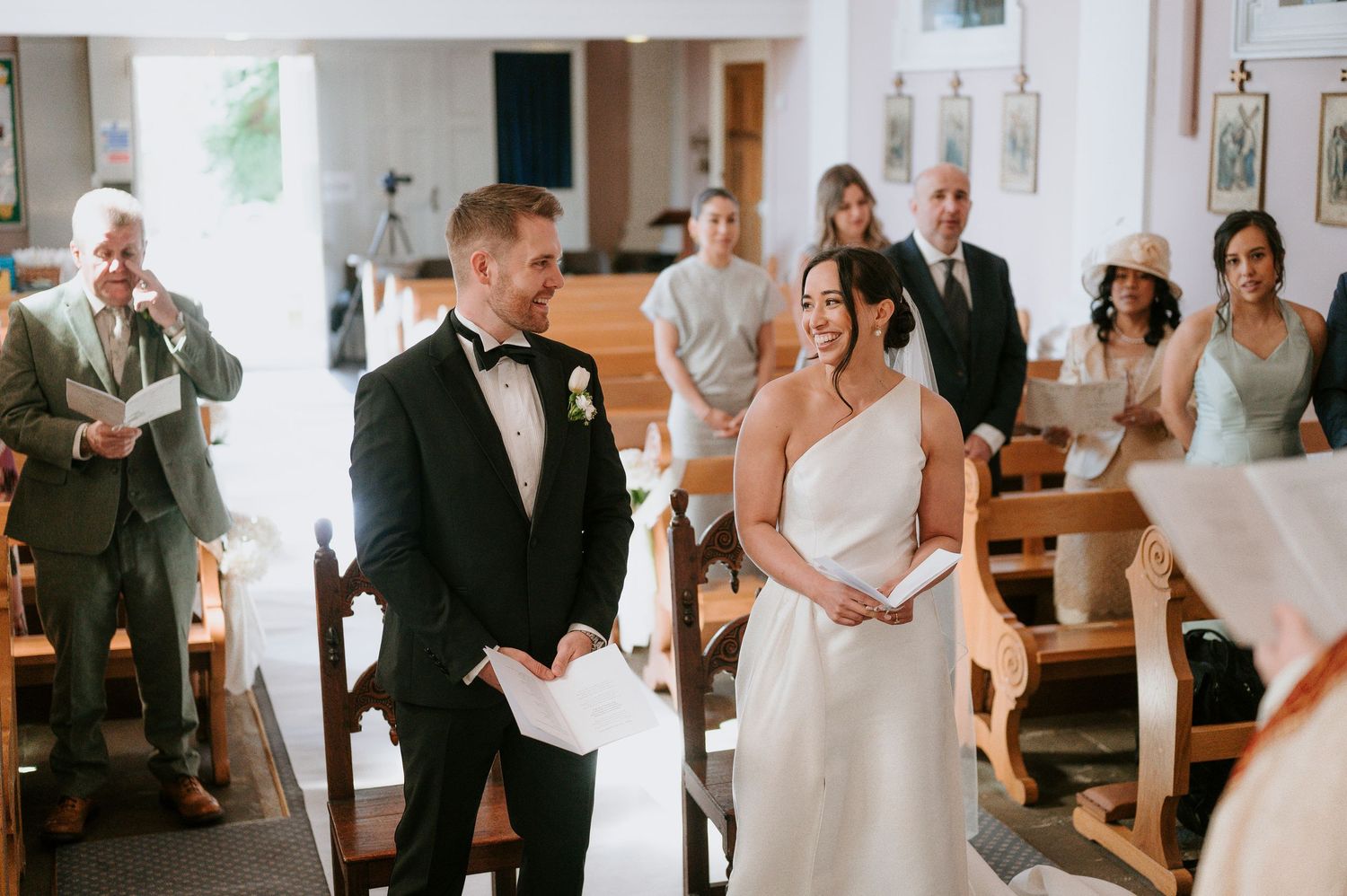 A series of candid wedding moments showing couples and guests interacting during a joyful indoor ceremony celebration.