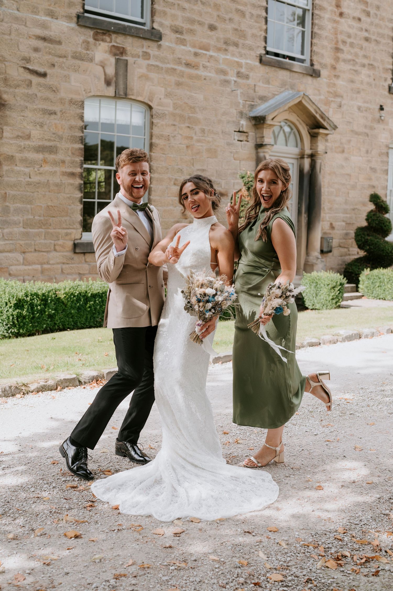 A wedding party laughs and dances together in a playful sequence of candid moments outside a stone building.