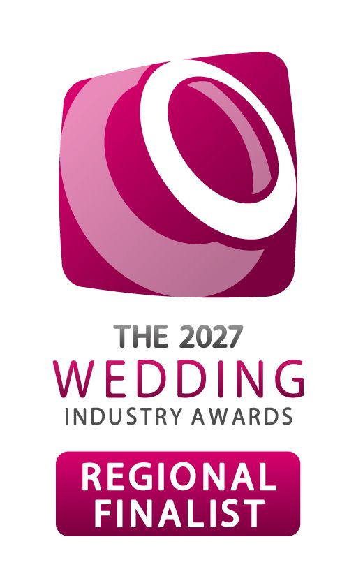 The 2027 Wedding Industry Awards Regional Finalist badge with a pink and white ring logo on a magenta rounded square.
