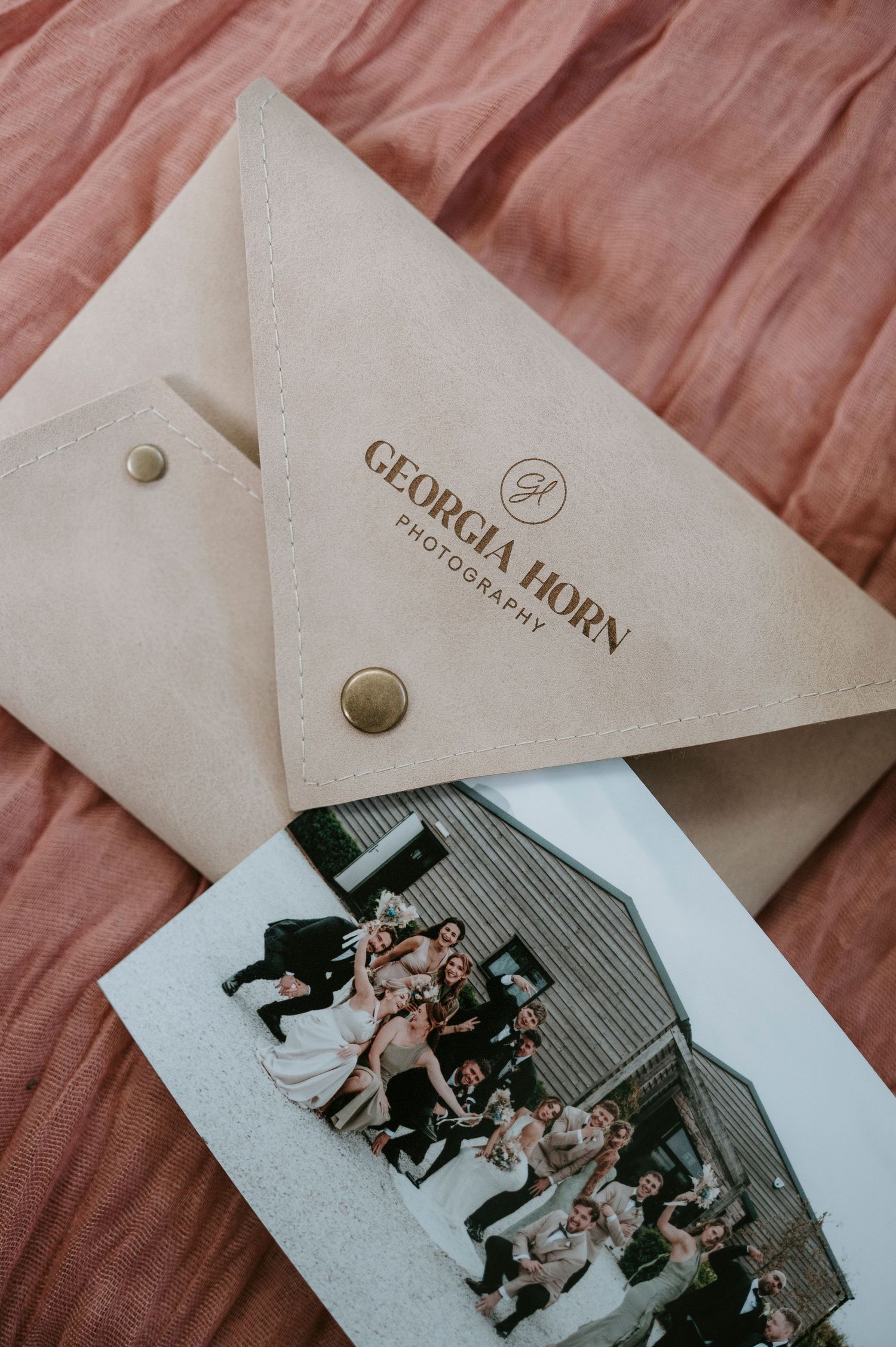 A series of vintage-style photographs arranged in a collage with a brown paper envelope labeled 'Geojohn'.