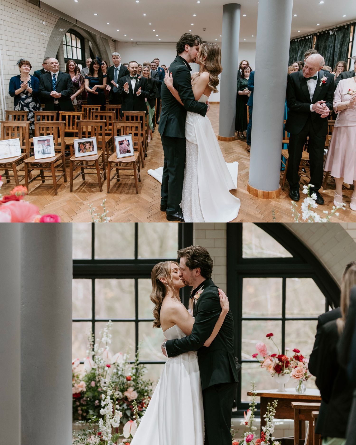A couple shares their first kiss as newlyweds in an elegant indoor venue with wooden chairs and floral decorations.