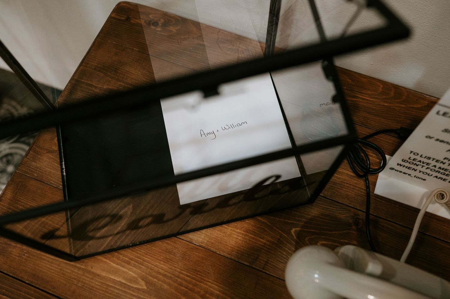 Dark wooden desk surface with scattered papers and documents in moody lighting.