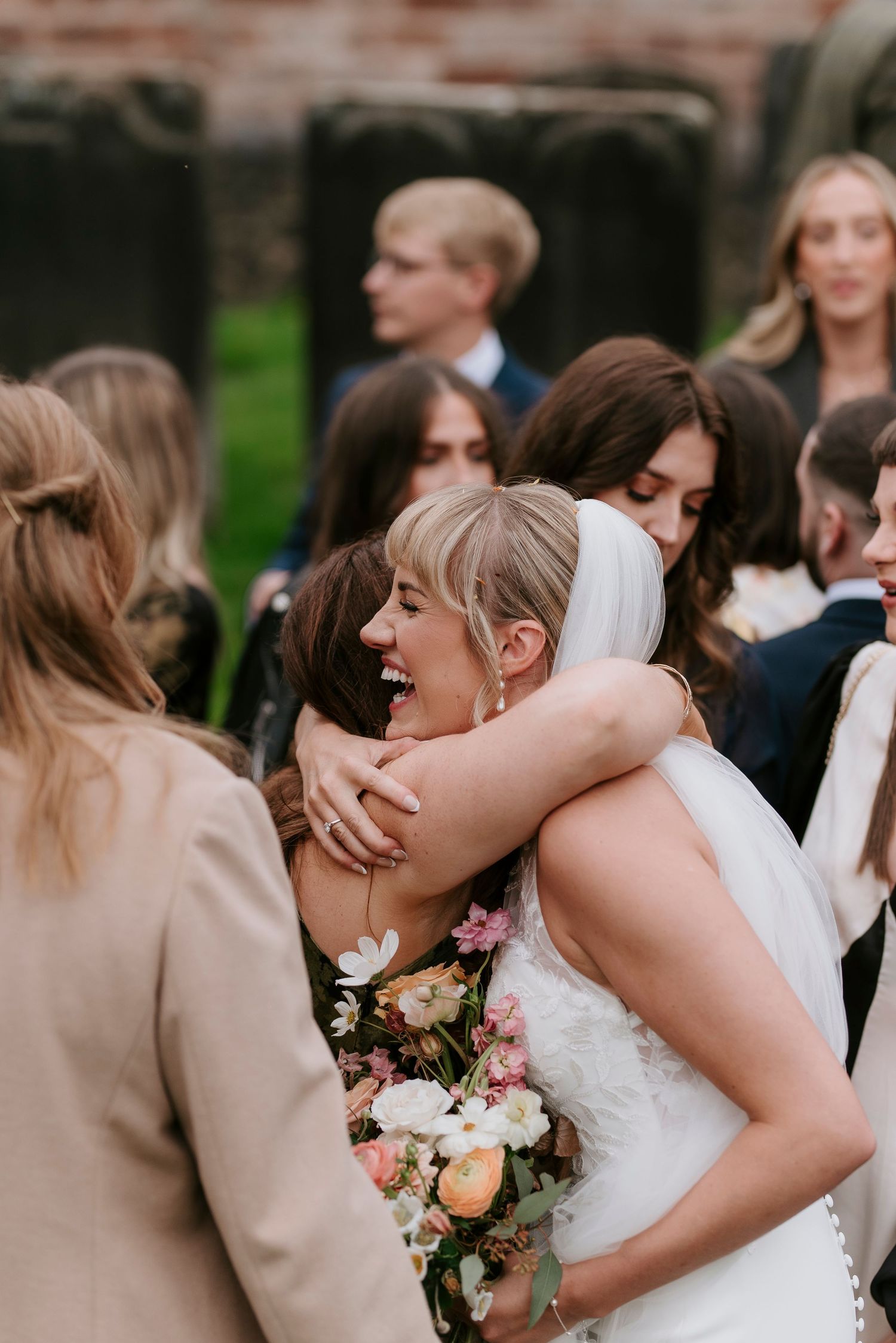 A series of candid wedding photos showing tender moments between guests during an outdoor celebration.