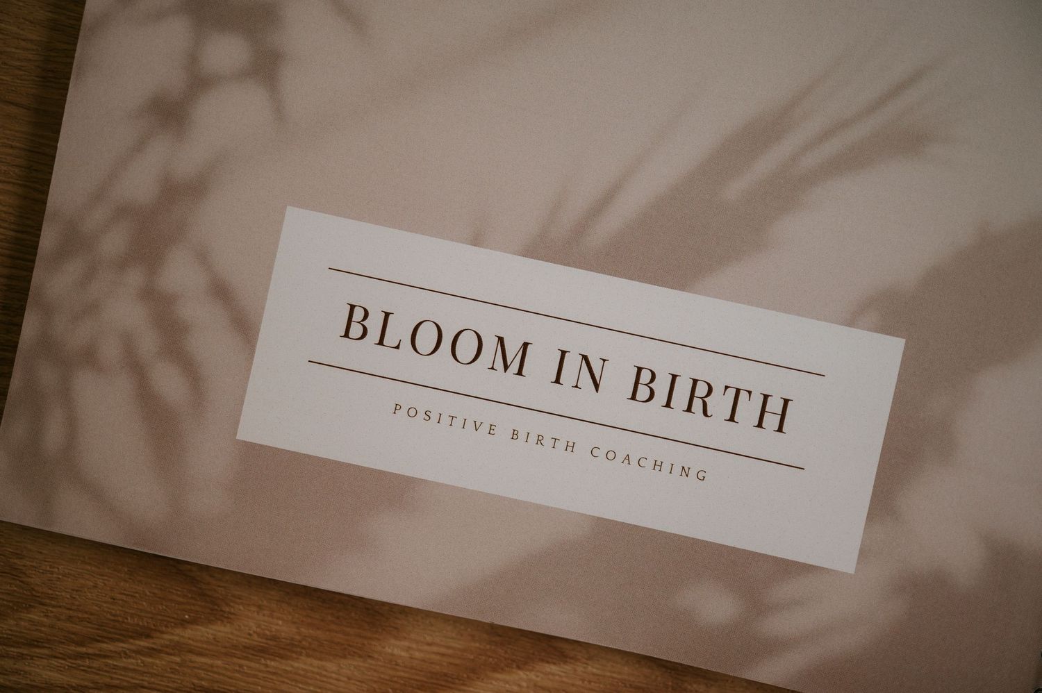 A minimalist wedding photography branding design with elegant text 'Bloom in Birth' on a light beige background.