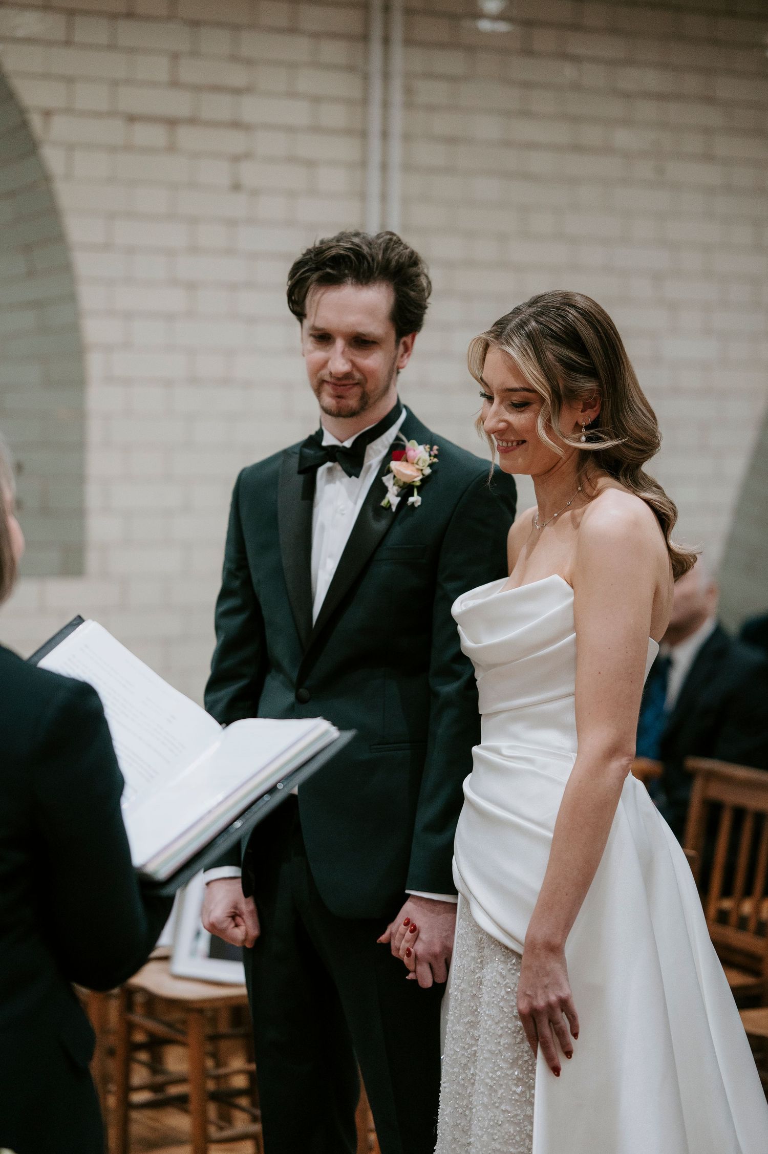 A joyful wedding couple shares a sweet moment together during their church ceremony.
