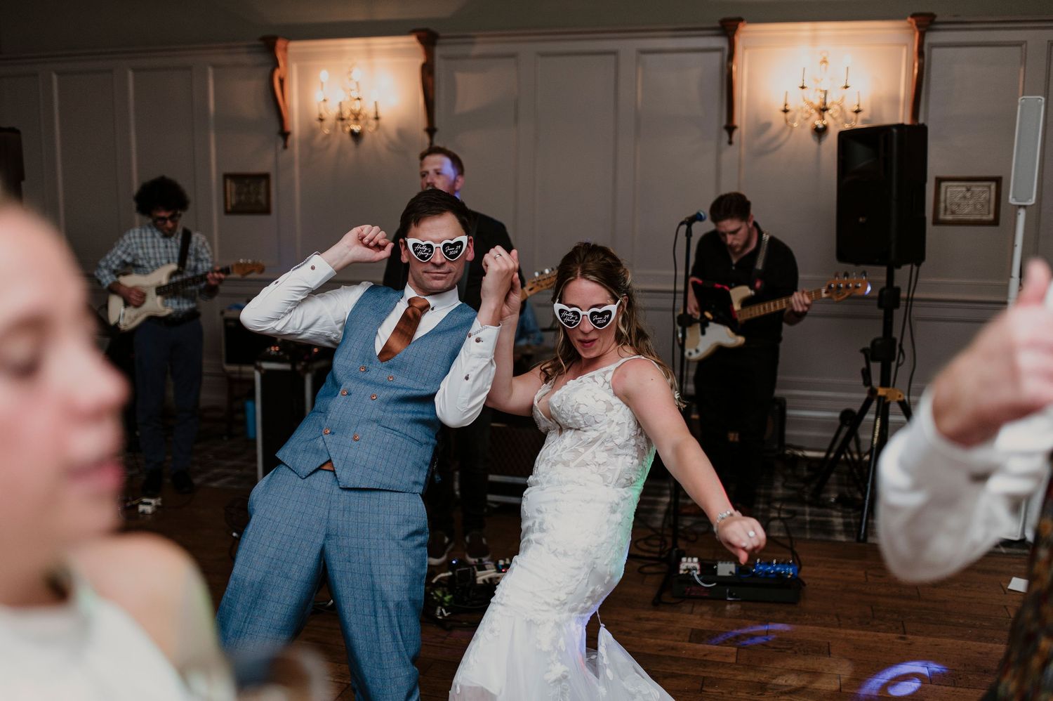Wedding party dances and celebrates with joyful energy on the reception dance floor.