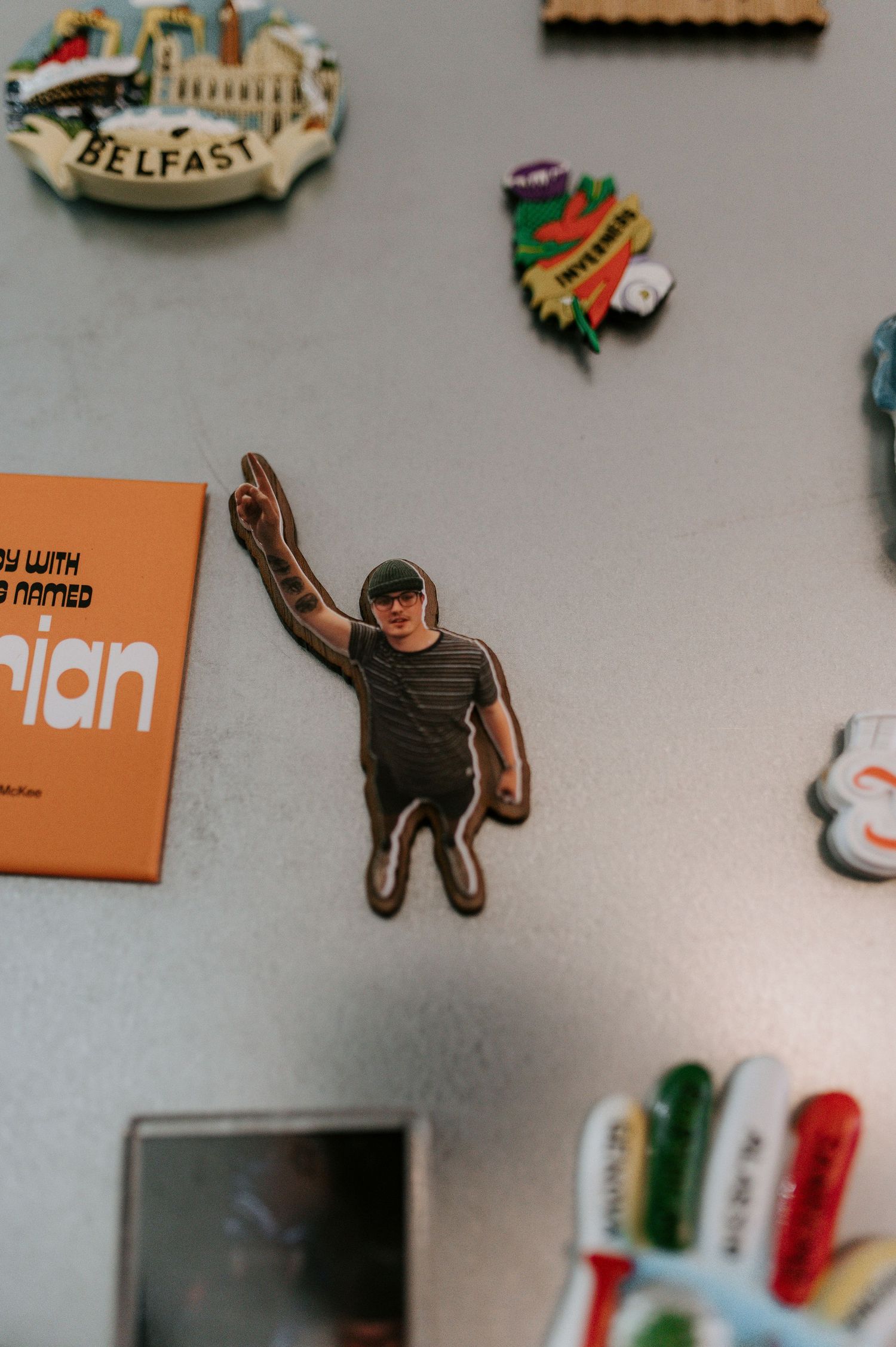 Orange branded stickers and decorative items displayed on a light gray surface.
