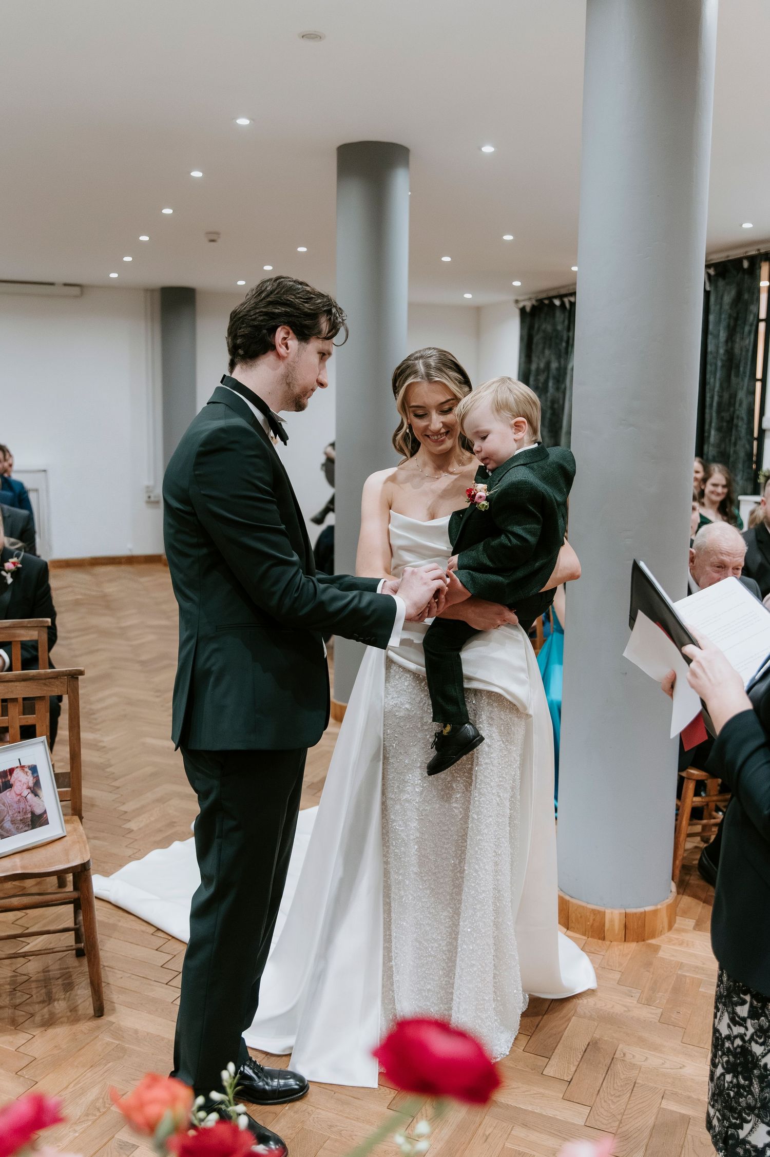 A sequence of wedding photos showing a couple dancing and embracing in an elegant venue with white columns.