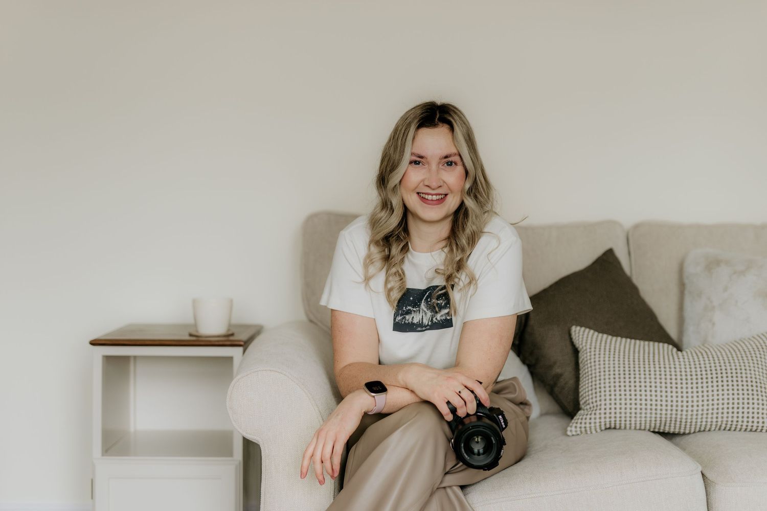 A series of minimalist lifestyle photos showing a person in casual attire with photography equipment and home decor elements.