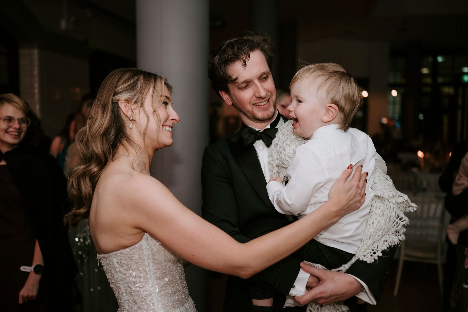 Joyful dancing and celebration moments captured at an indoor wedding reception.