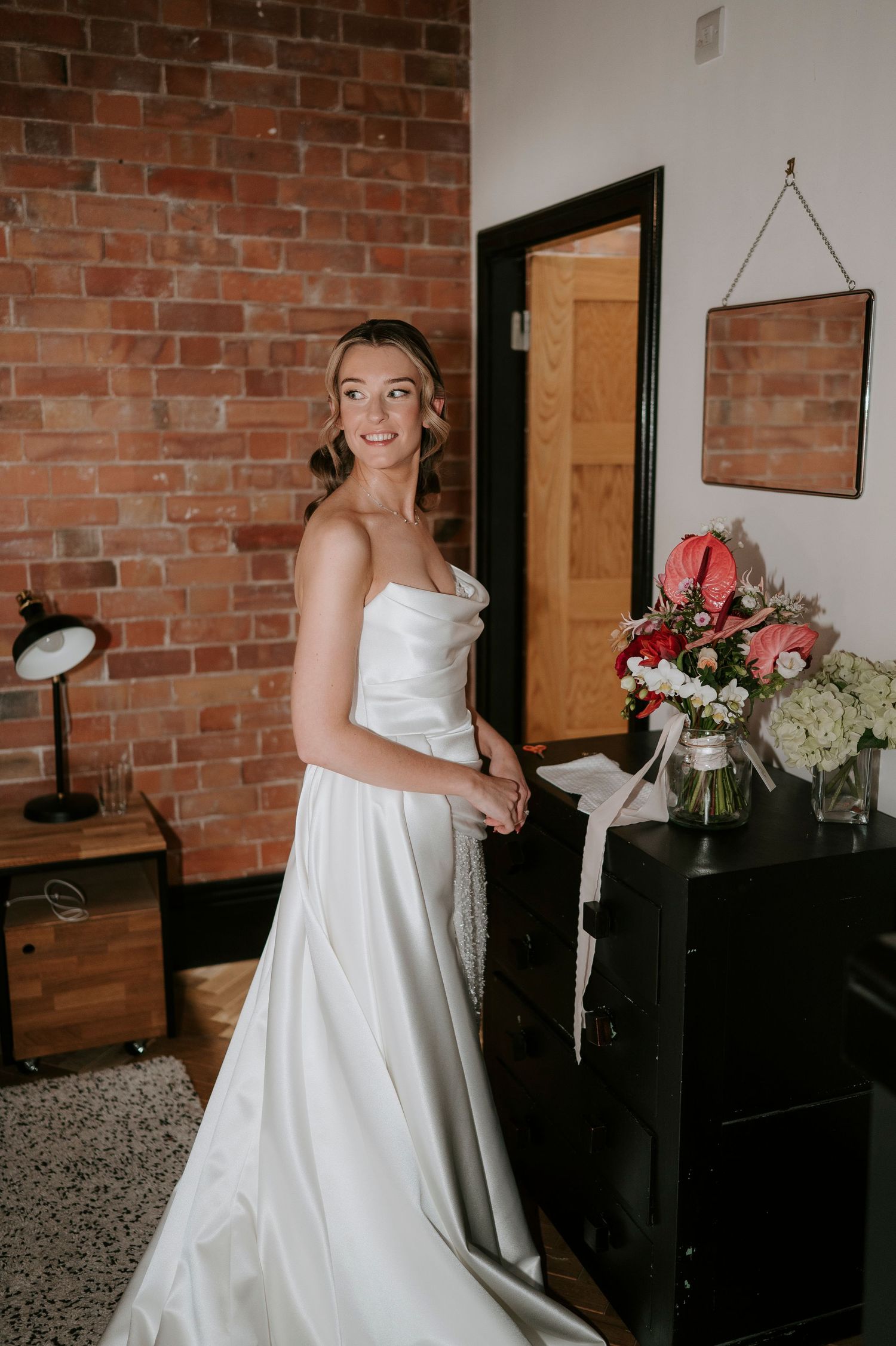 A series of joyful moments in a white wedding dress against exposed brick walls and modern decor.