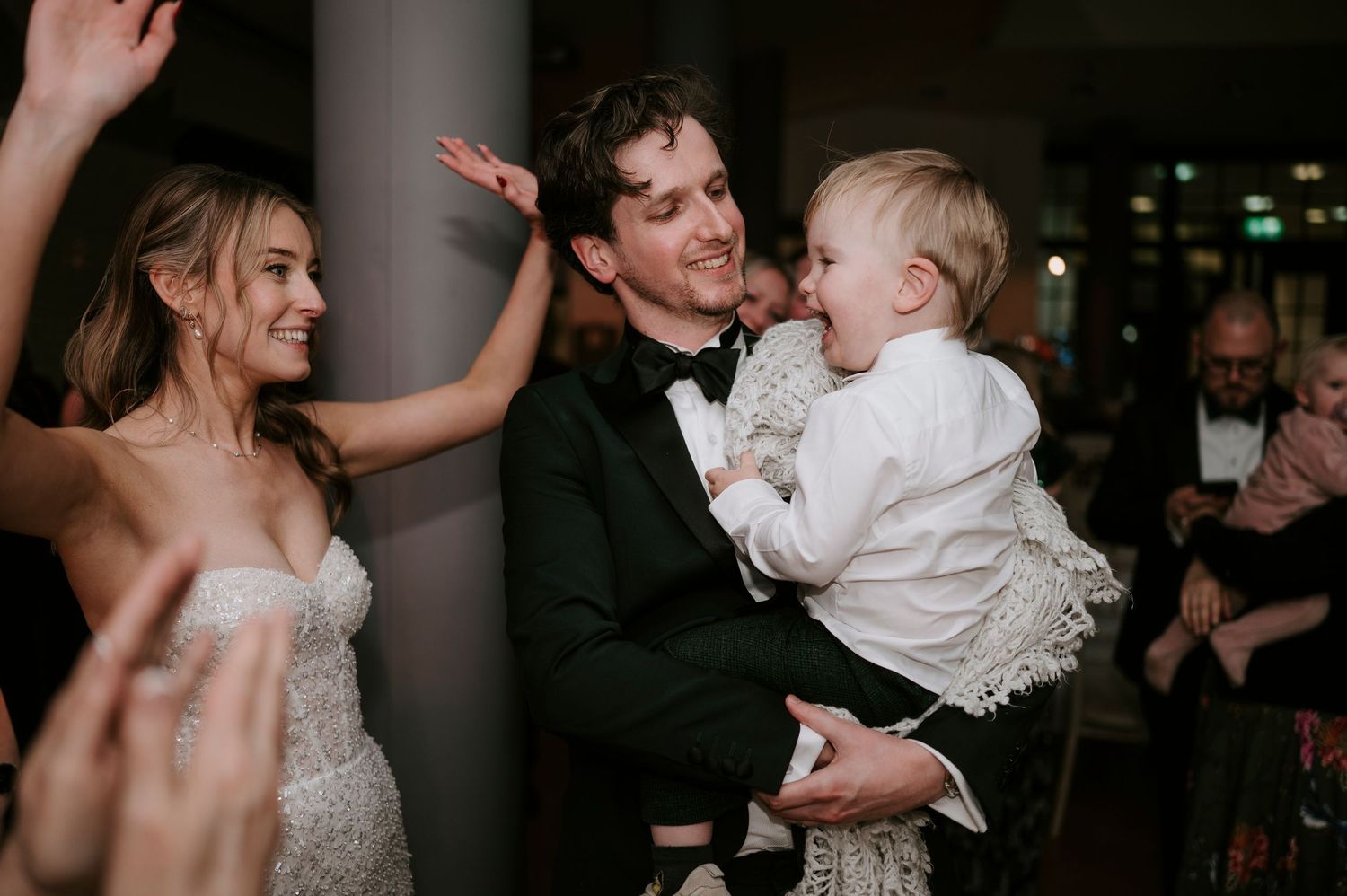 Wedding party dances and celebrates during lively reception moments.