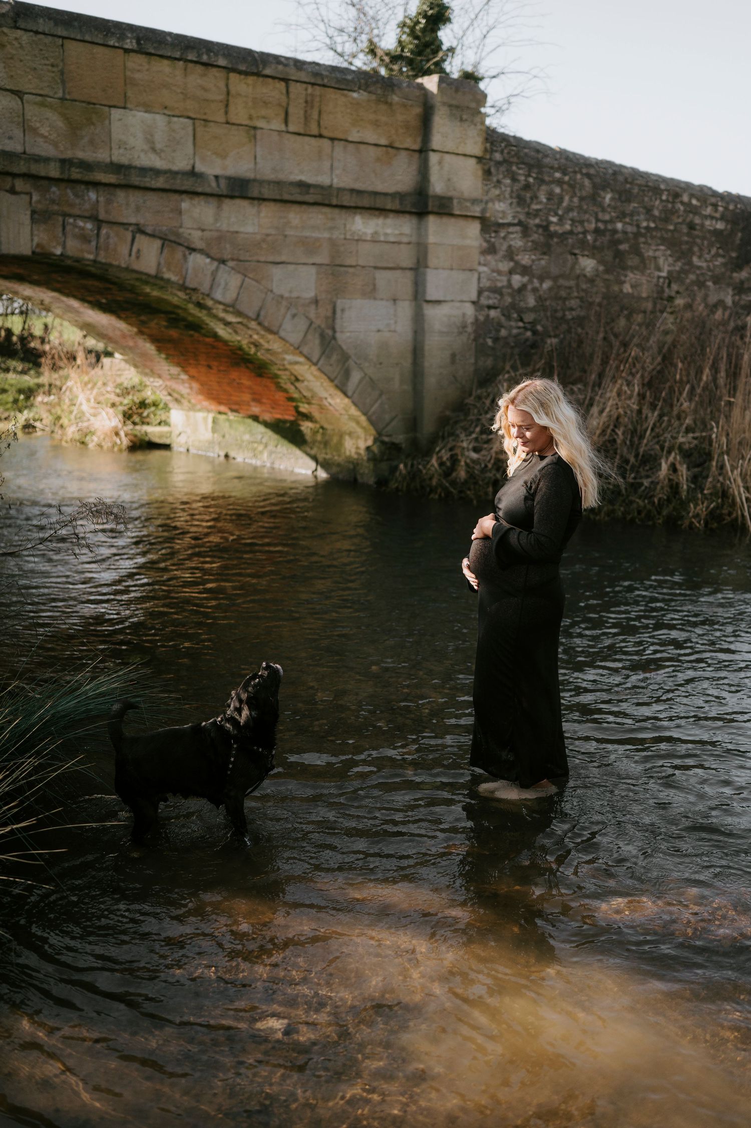 A sequence of photos shows a person falling backwards into a river from a stone bridge.