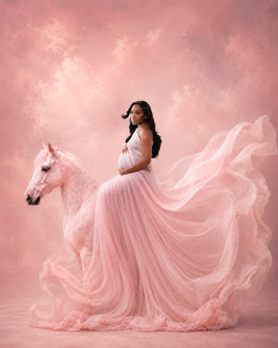 Pregnant woman in pink tulle gown poses beside a white horse in a dreamy maternity portrait.