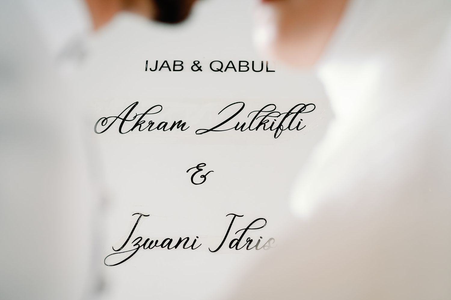 Elegant calligraphy wedding sign reading Ijab and Qabul for Akram Zulhifli and Izwani Idris.