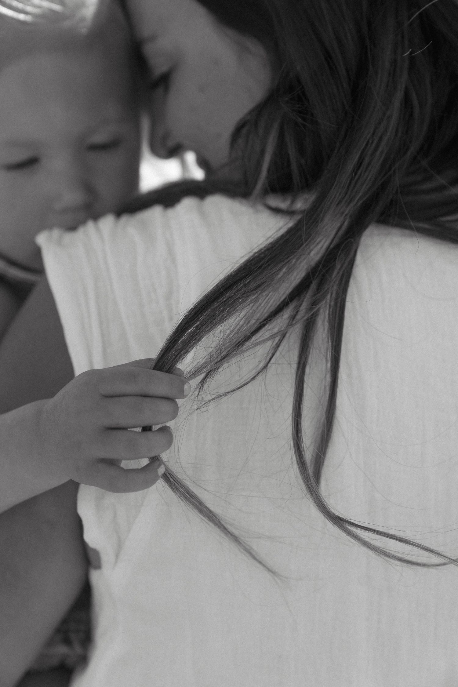 Signature motherhood portraits in Regina, Saskatchewan capturing authentic connection between mothers and their children.