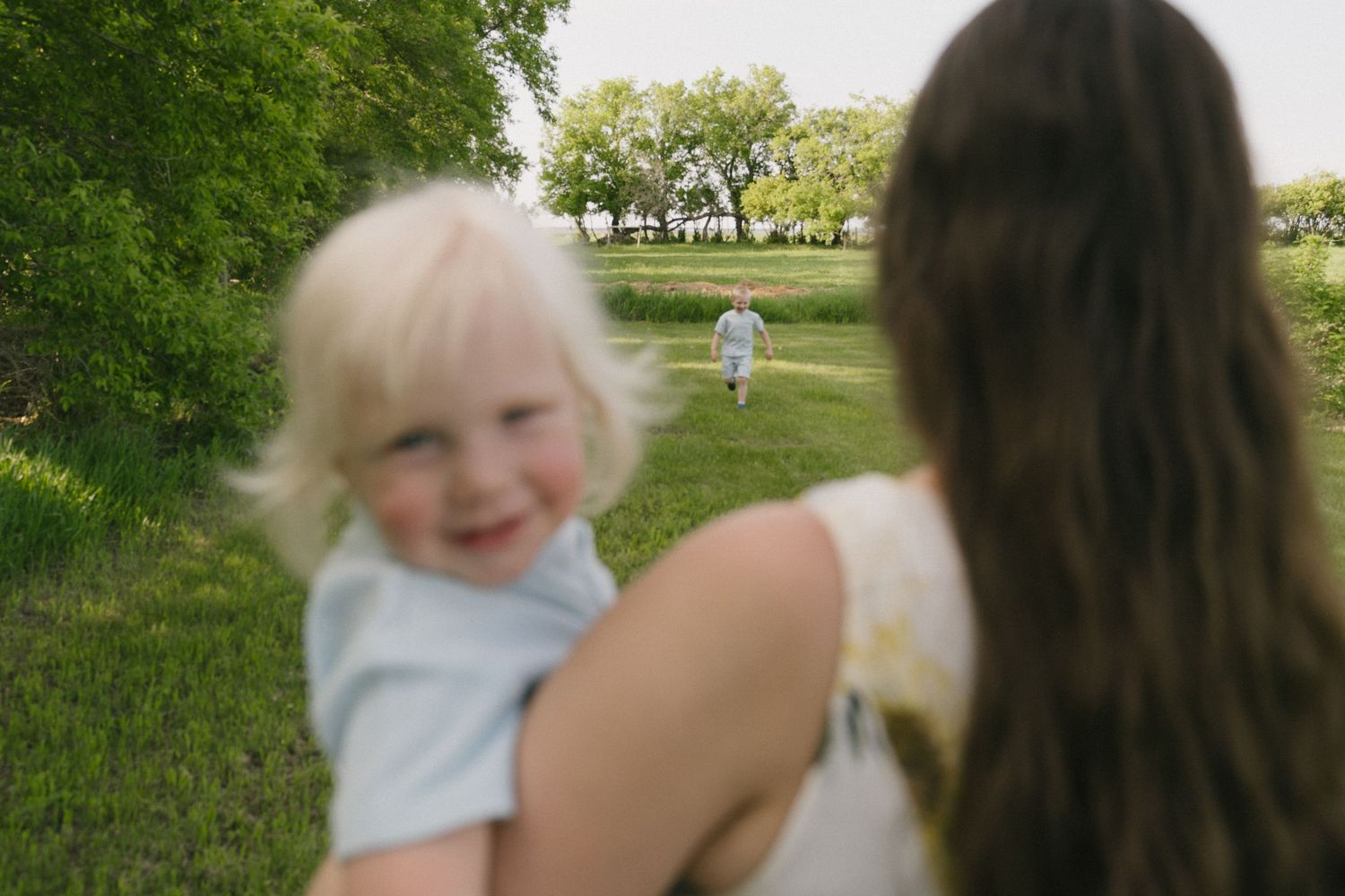 Signature motherhood portraits in Regina, Saskatchewan capturing authentic connection between mothers and their children.