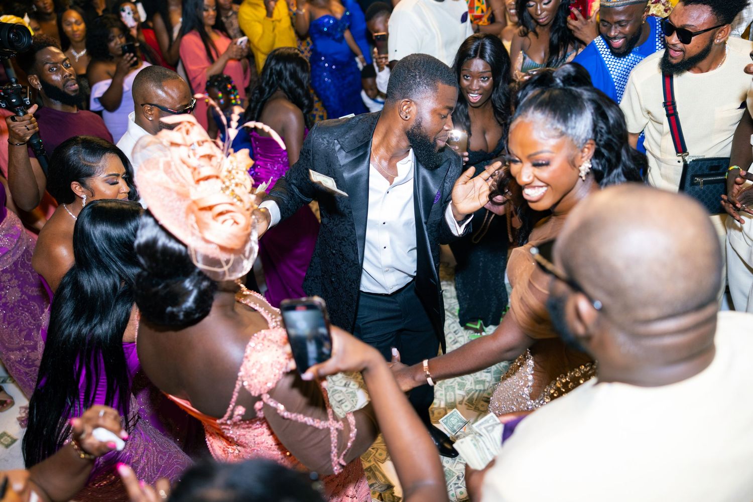 Energetic crowd dancing and enjoying themselves at a festive wedding reception.